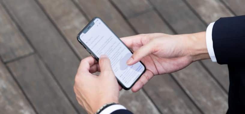 Closeup of Rex Leung’s hands holding a phone, reading a client message.