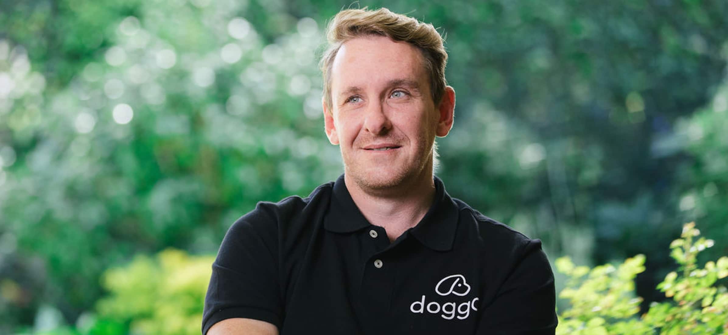 Graeme Bettles wearing his Doggo polo shirt and smiling.