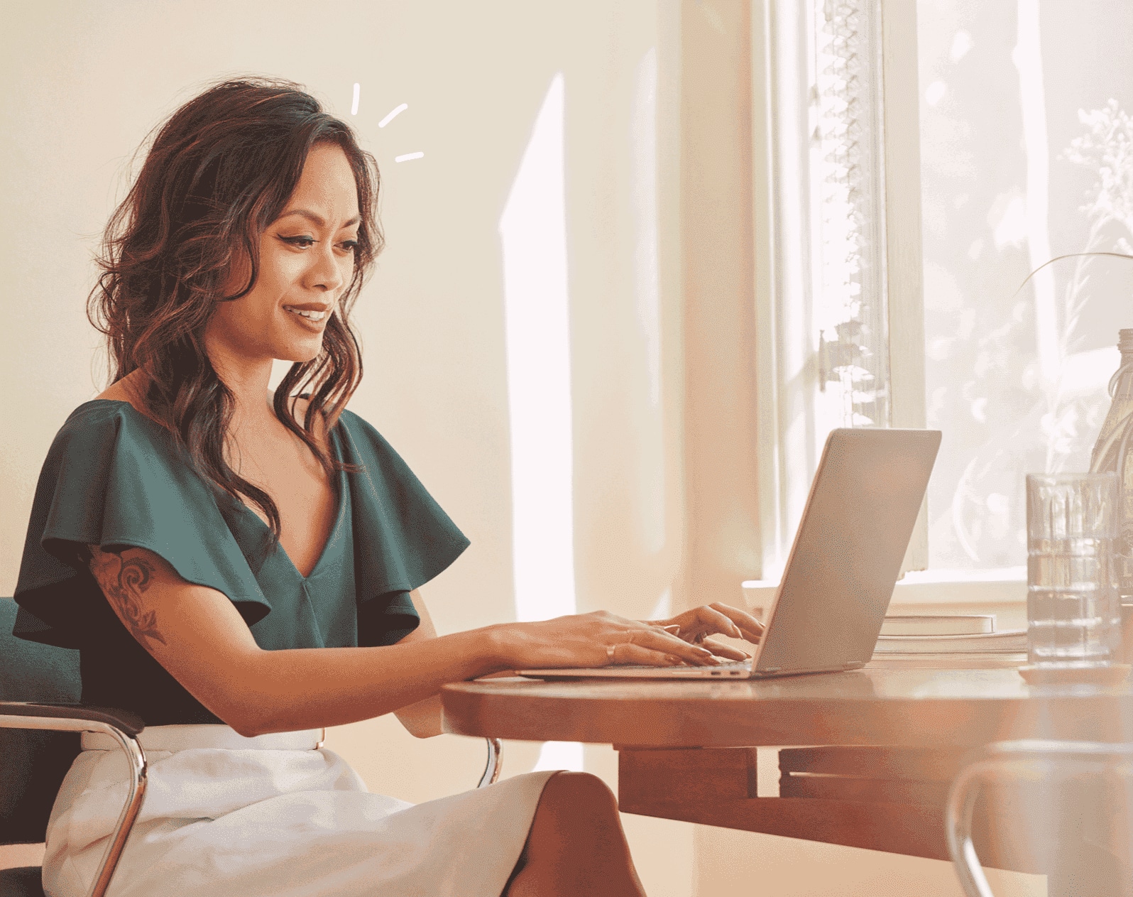 Person using Making Tax Digital VAT software on their laptop, in a sunny home setting.