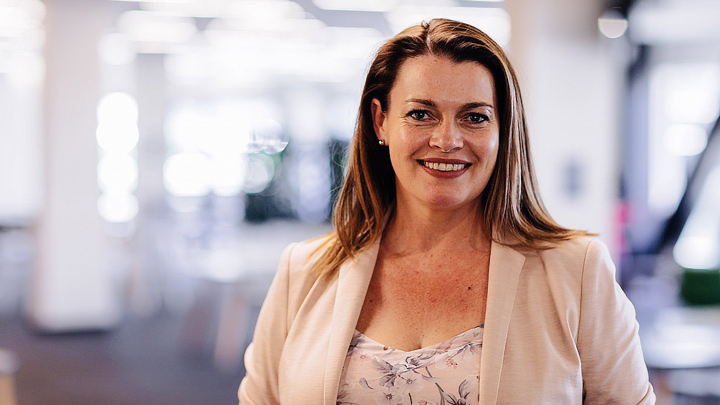 Head and shoulders of Sally Hams from Balance Books, standing in an office. 