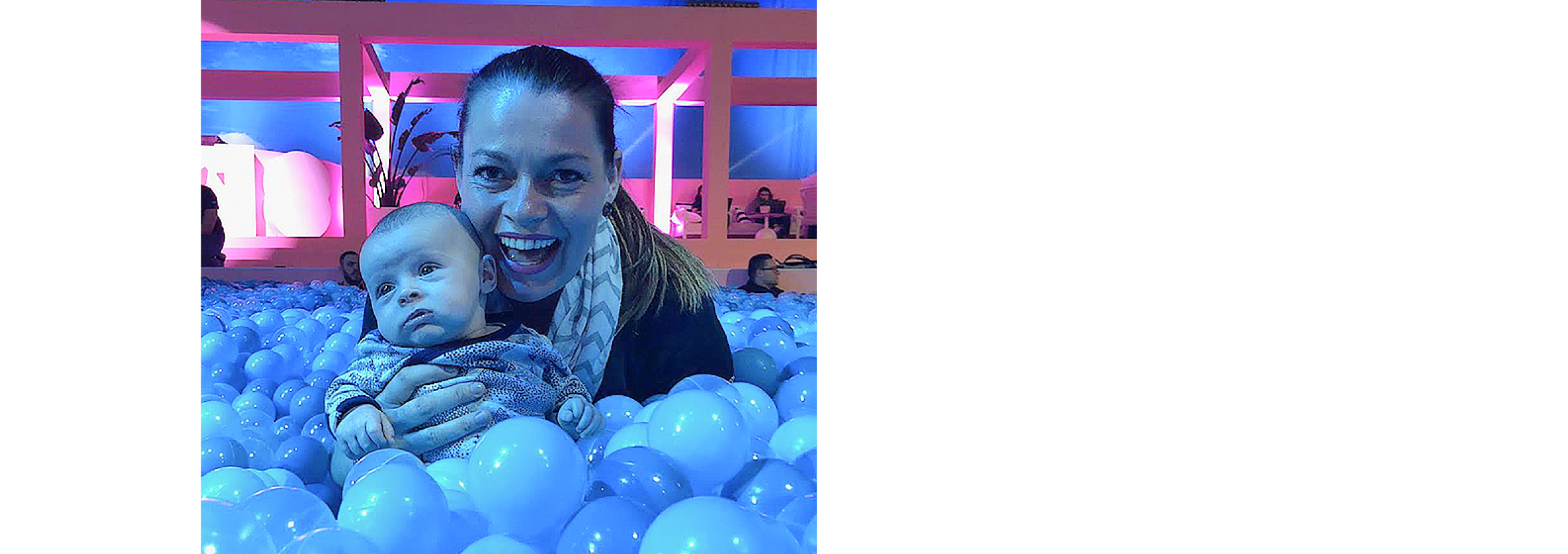 Sally at Xerocon sits with six-week-old son Matthew in a playing ball pit.