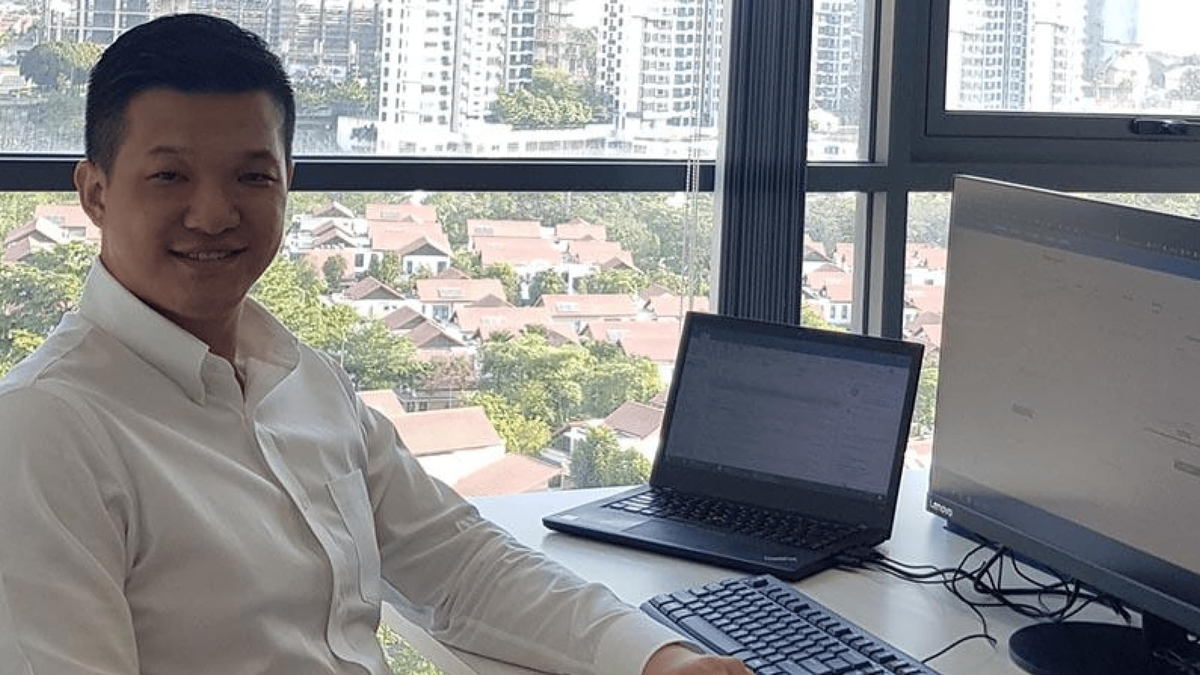 Ng Wing Siang of Neutral Consulting sitting at his desk by a window.