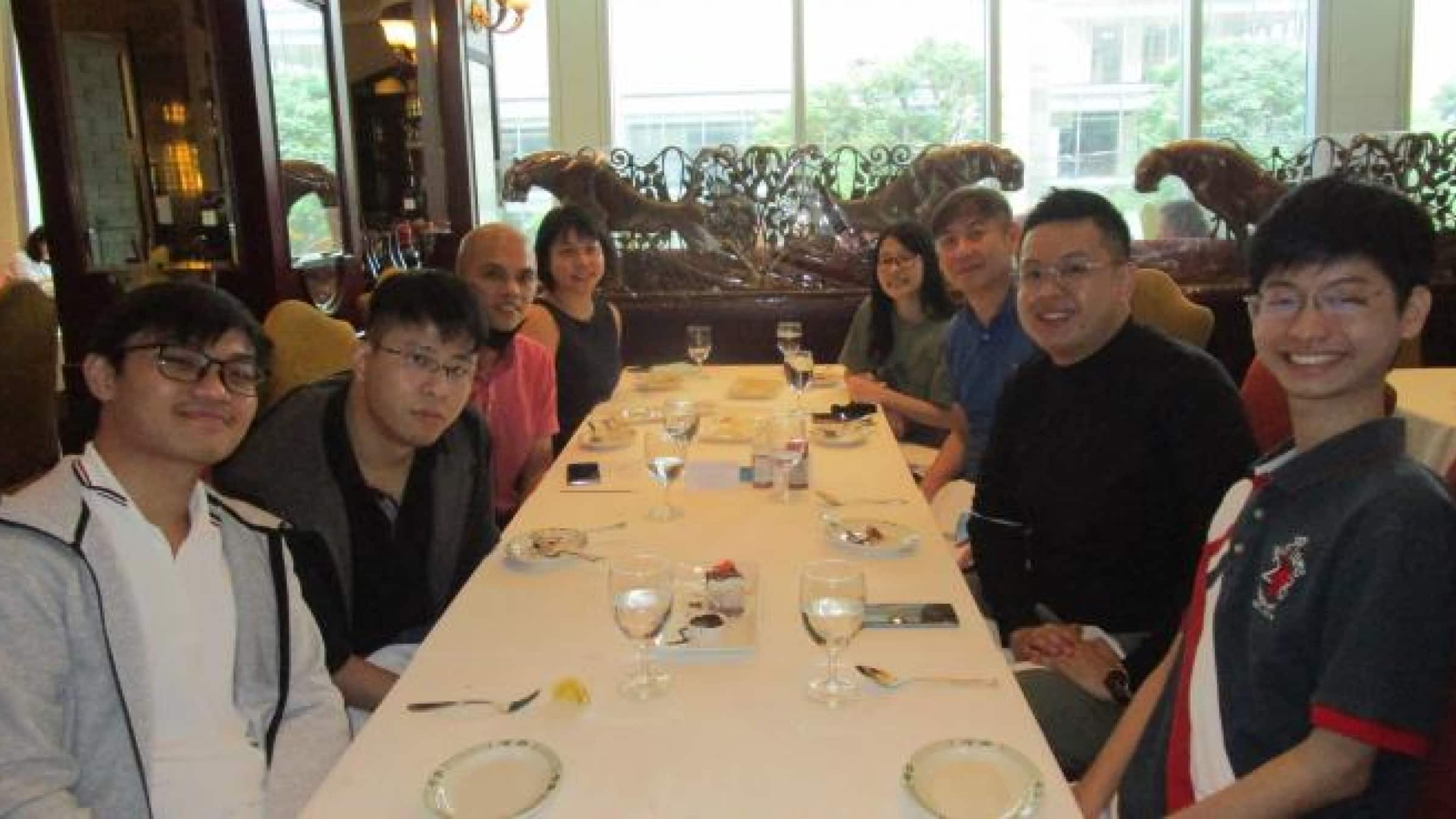 The Numbers Management team sitting together at a restaurant table.