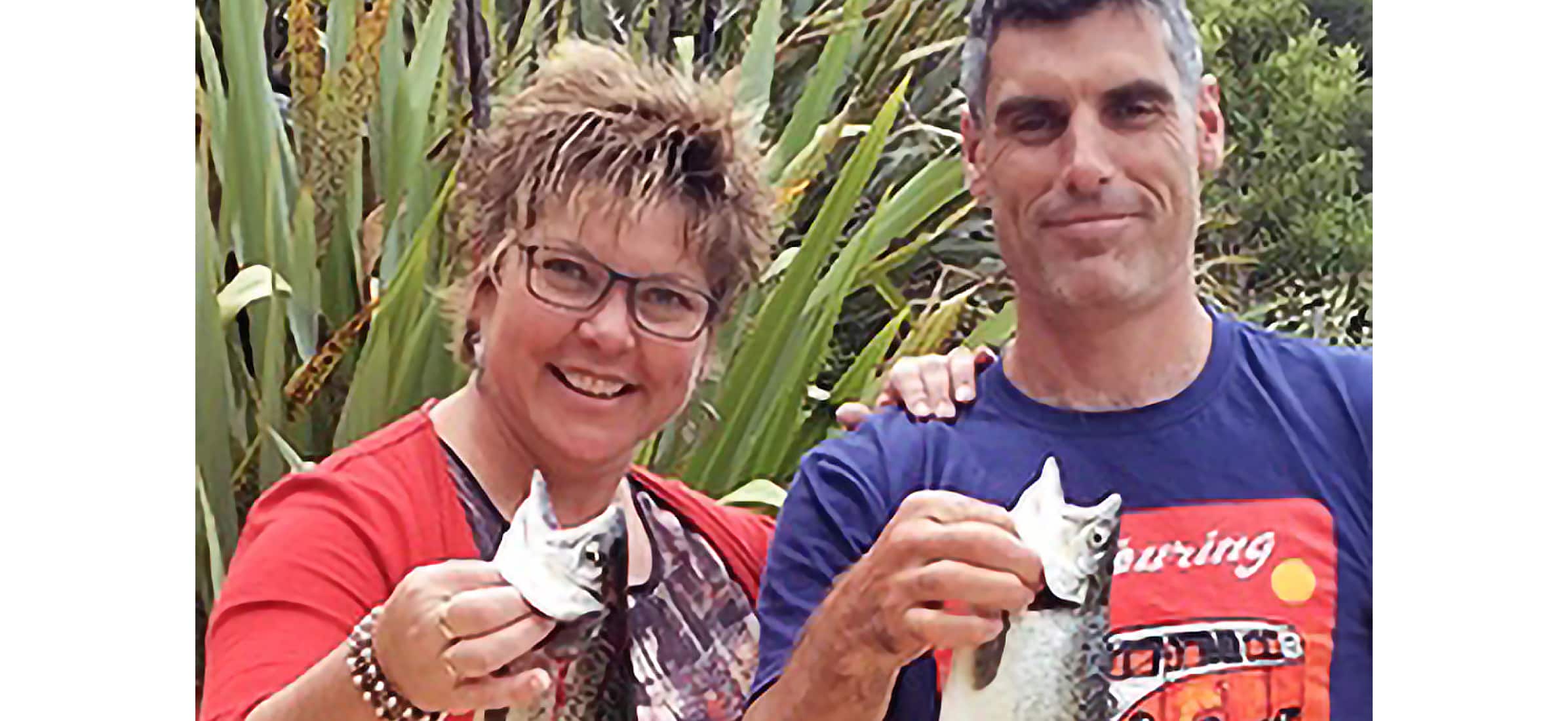 Di Crawford-Errington and husband Paul Errington holding up freshly caught fish.
