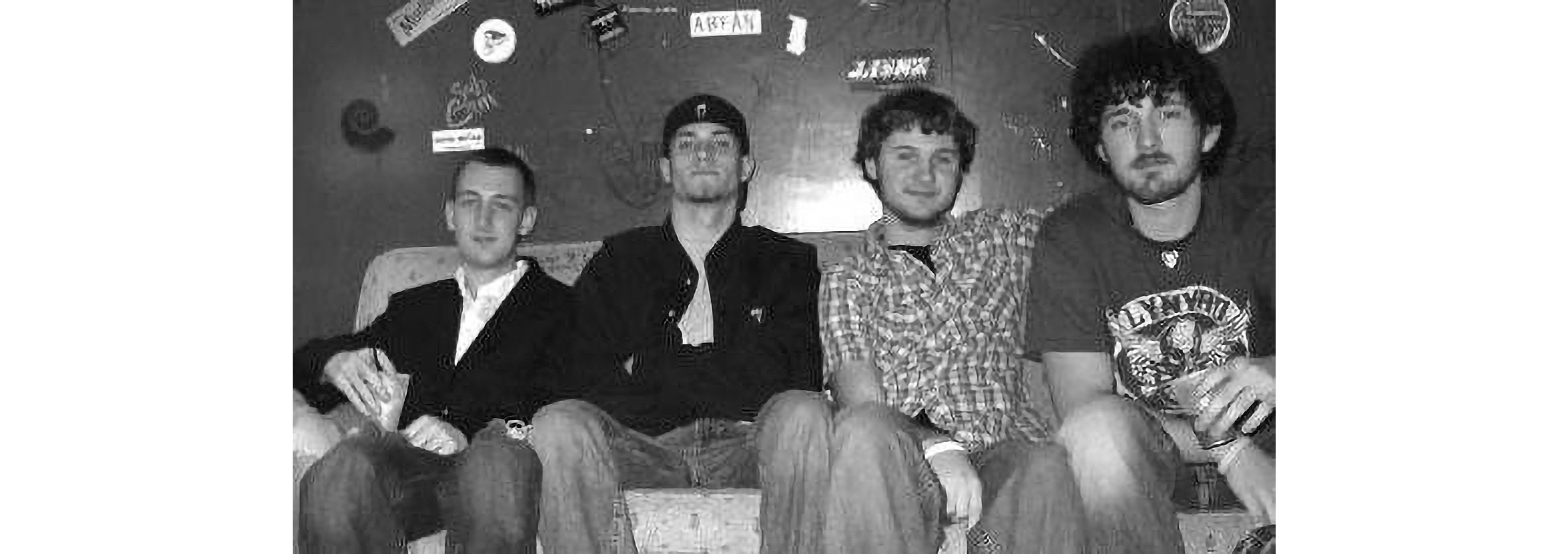 Tate Henshaw sits on a couch with the three other members of his heavy metal band.