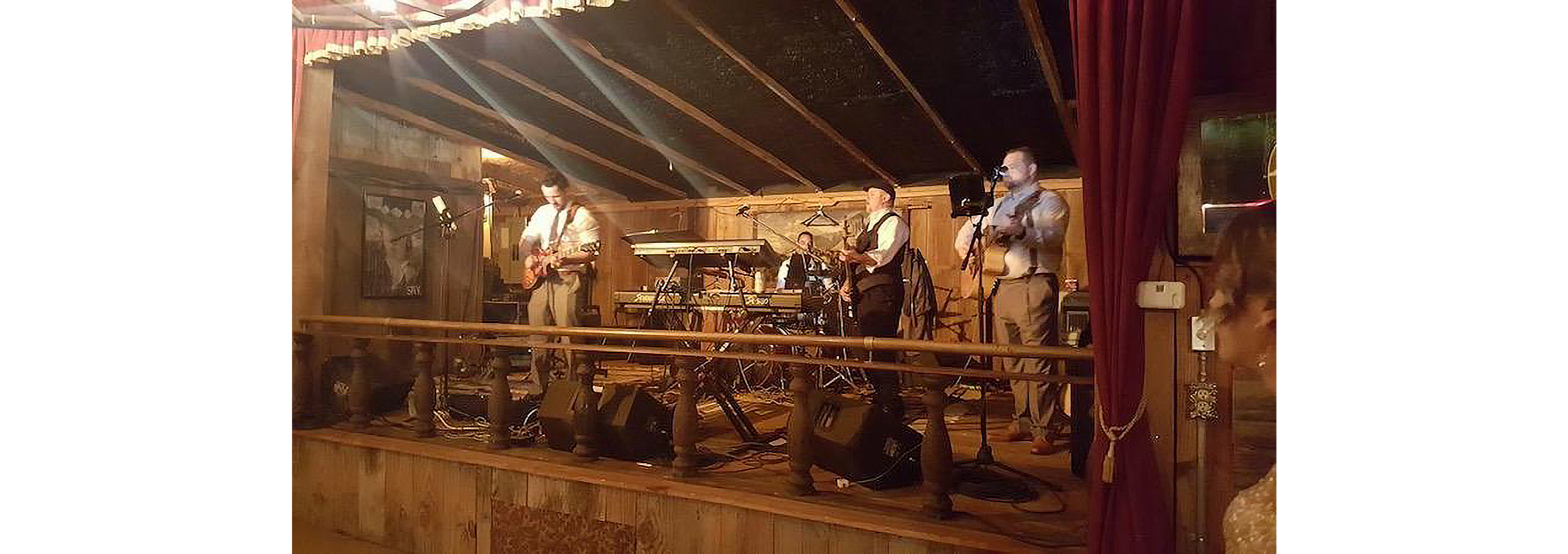 Tate Henshaw playing guitar his band, two other guitarists and drummer, at a friend’s wedding in Rome, Georgia.