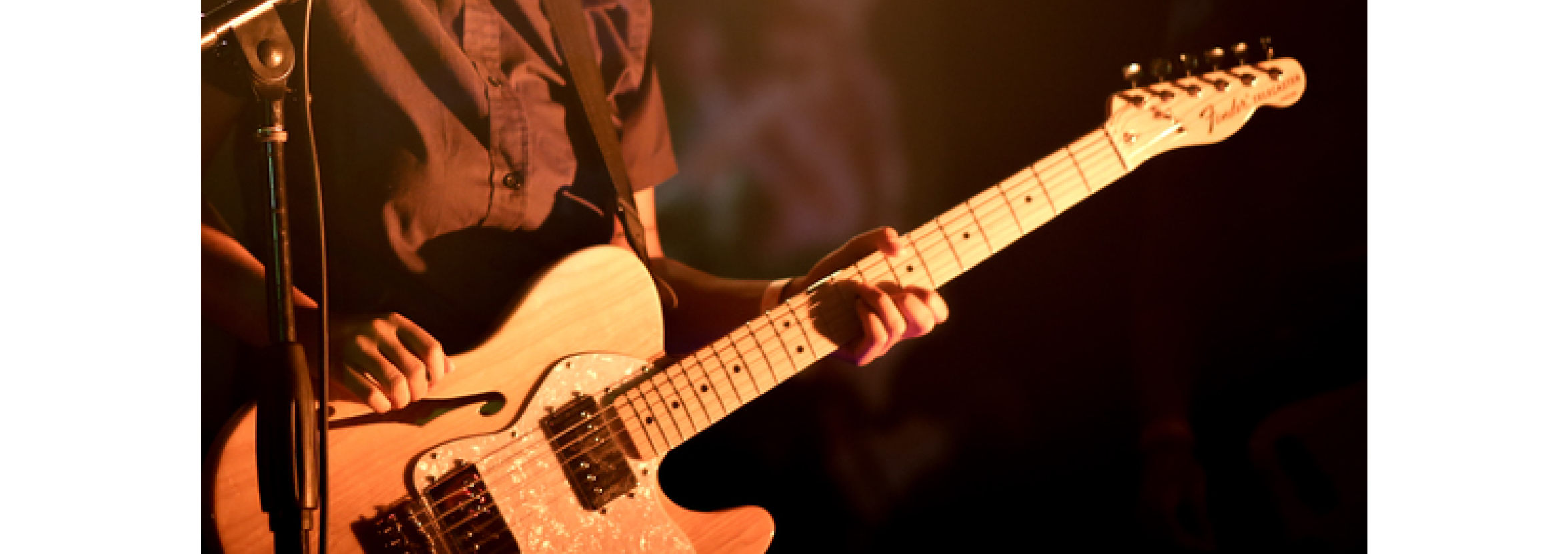 Close up of Paco’s hands playing electric guitar on stage.