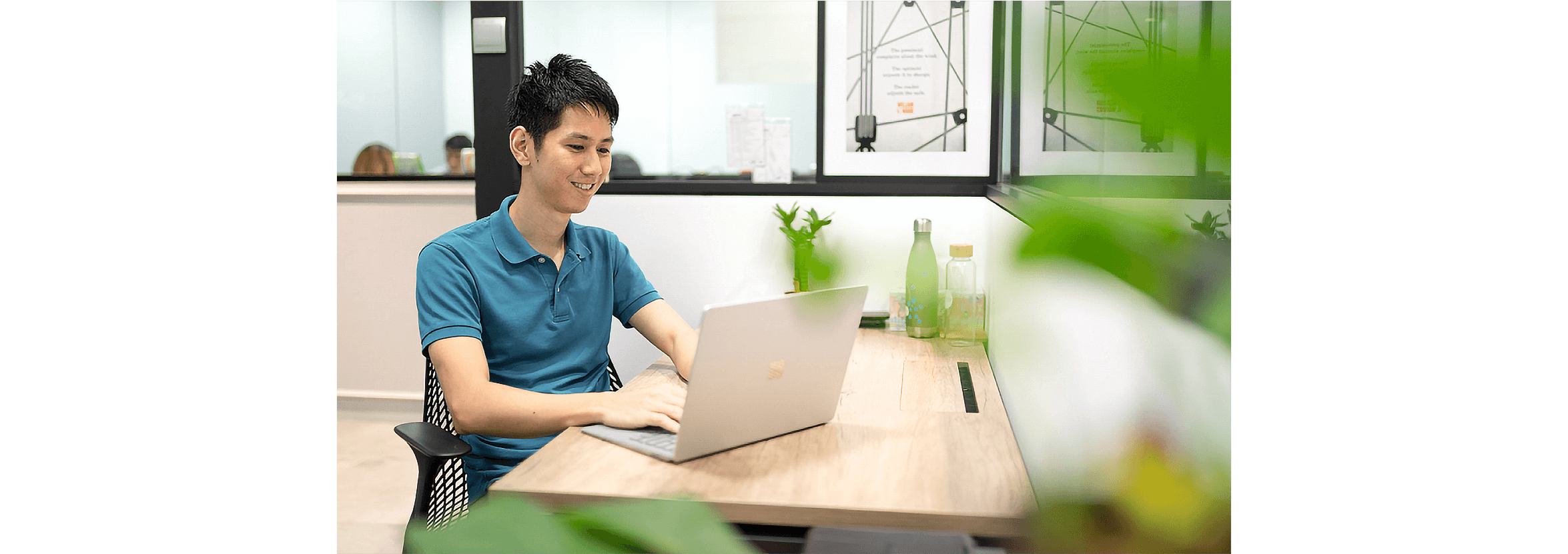 An accountant working on a laptop in their office.