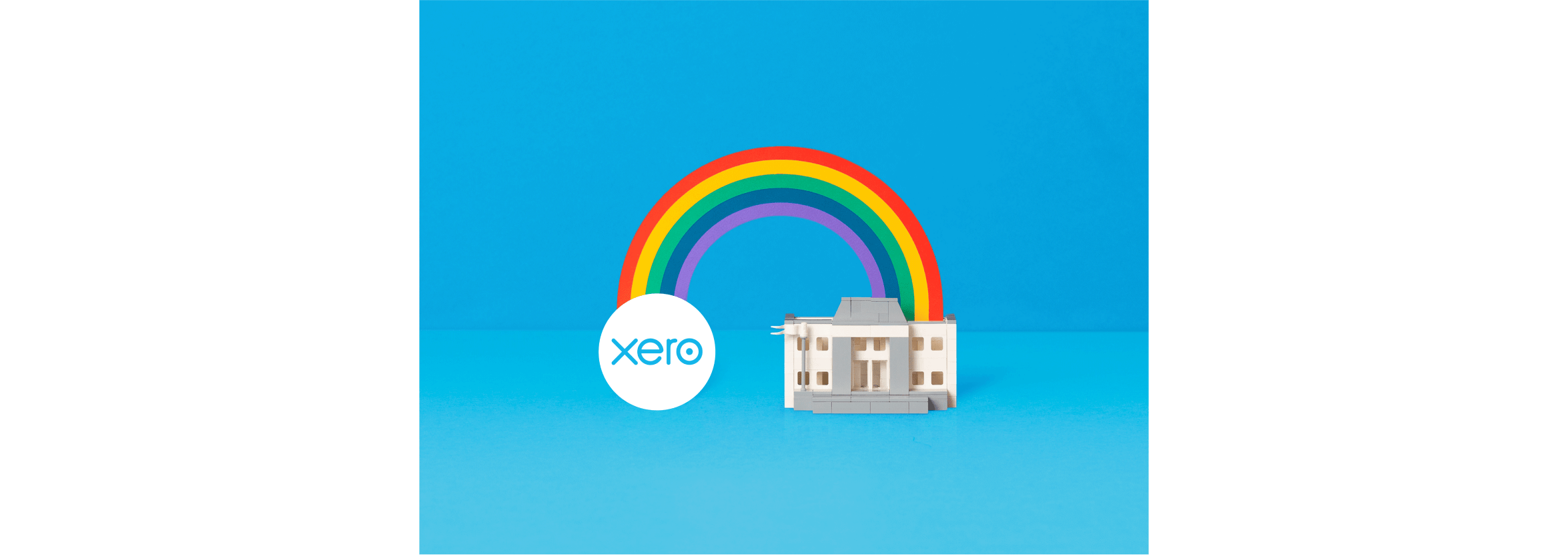 An illustration of a Xero logo and bank building are bridged by a coloured rainbow