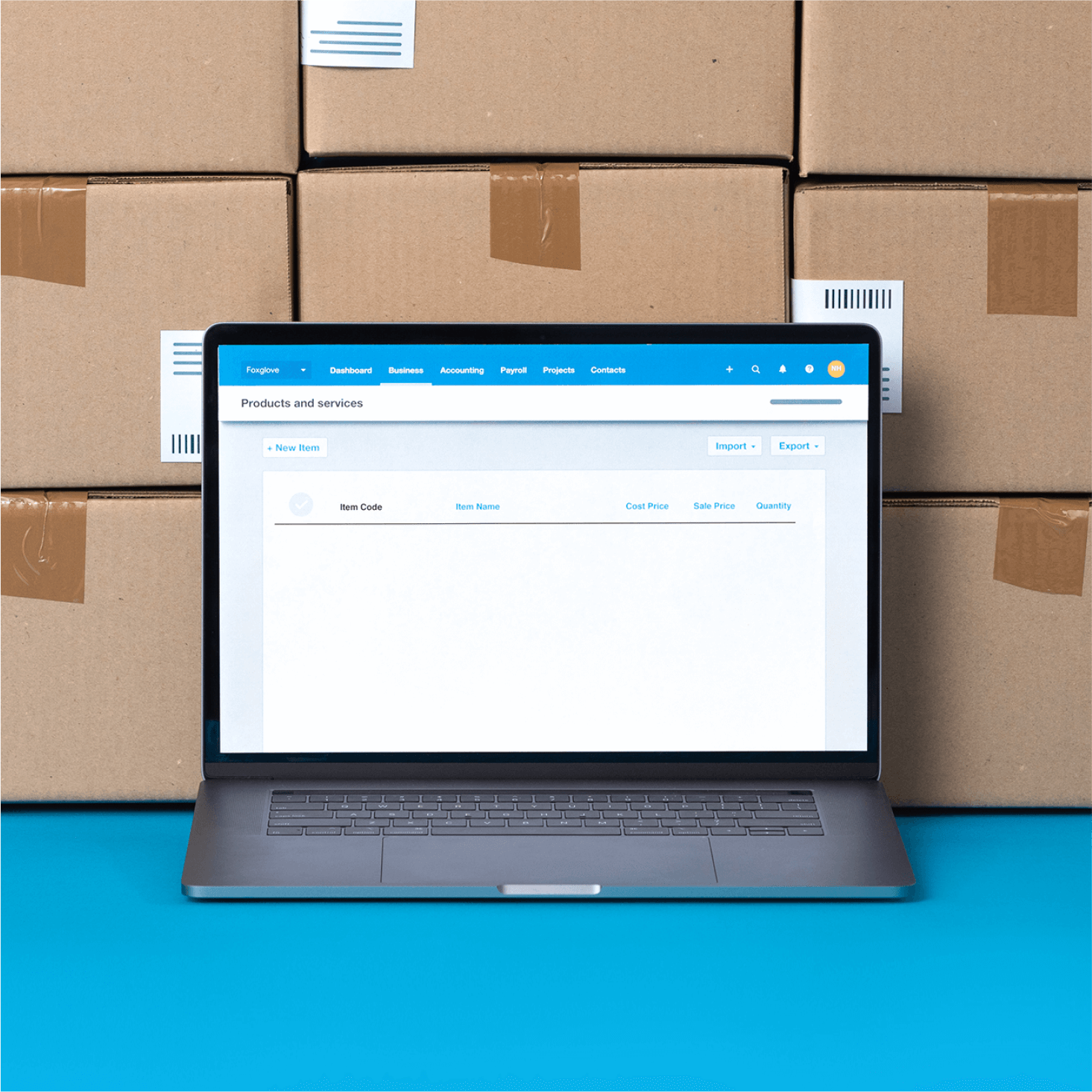 Unopened boxes containing new stock are stacked near a laptop that displays an inventory app.