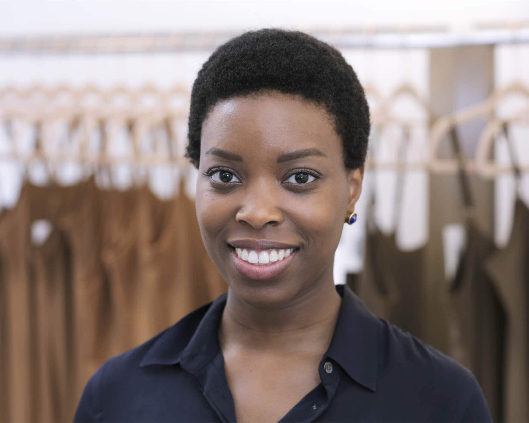 A person organizing clothes in retail store.