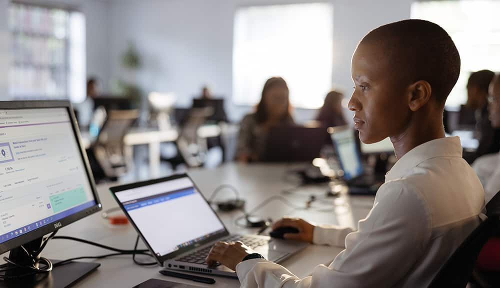 A student uses a computer to work through a business studies exercise online.