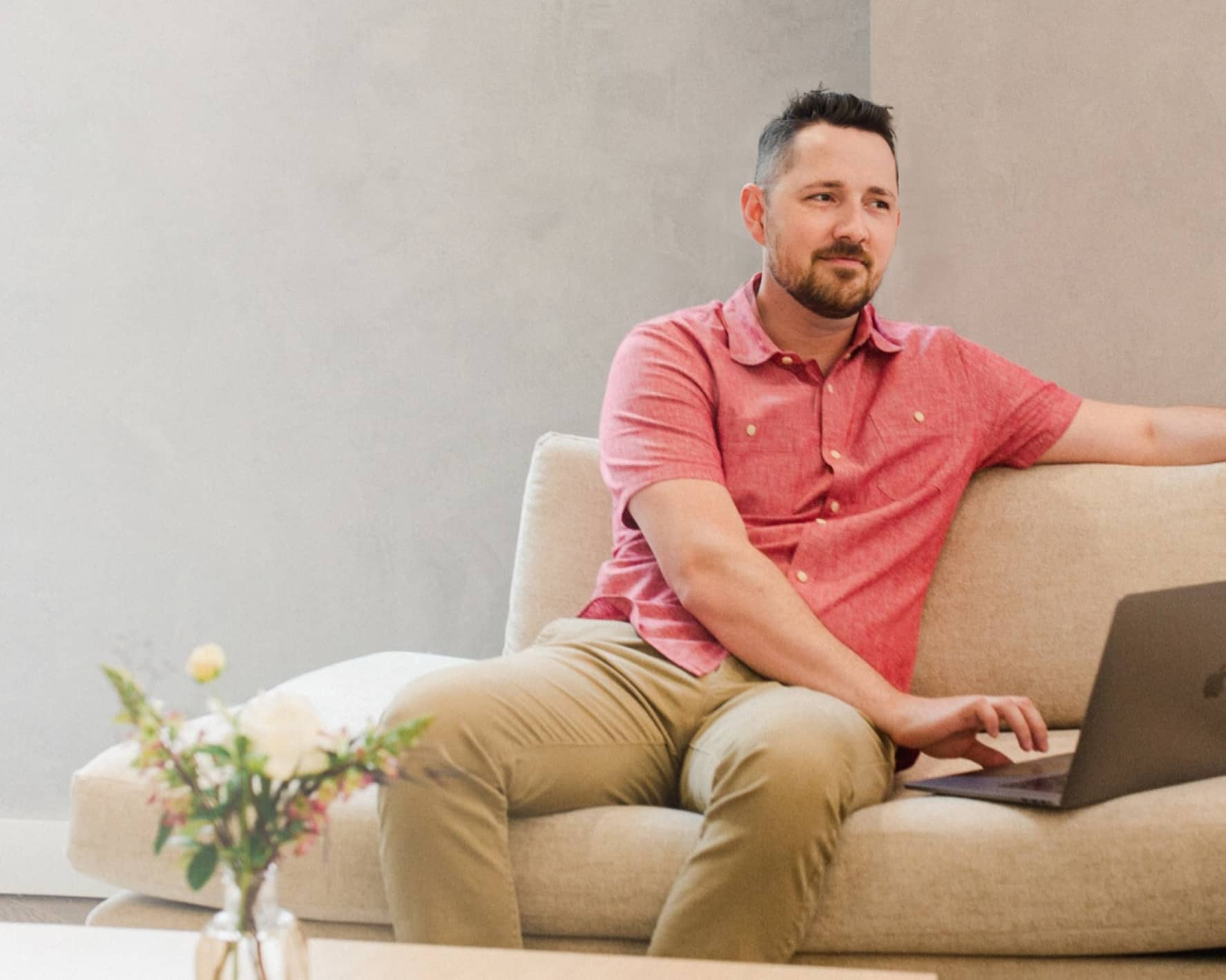 A person using a laptop on a couch at home