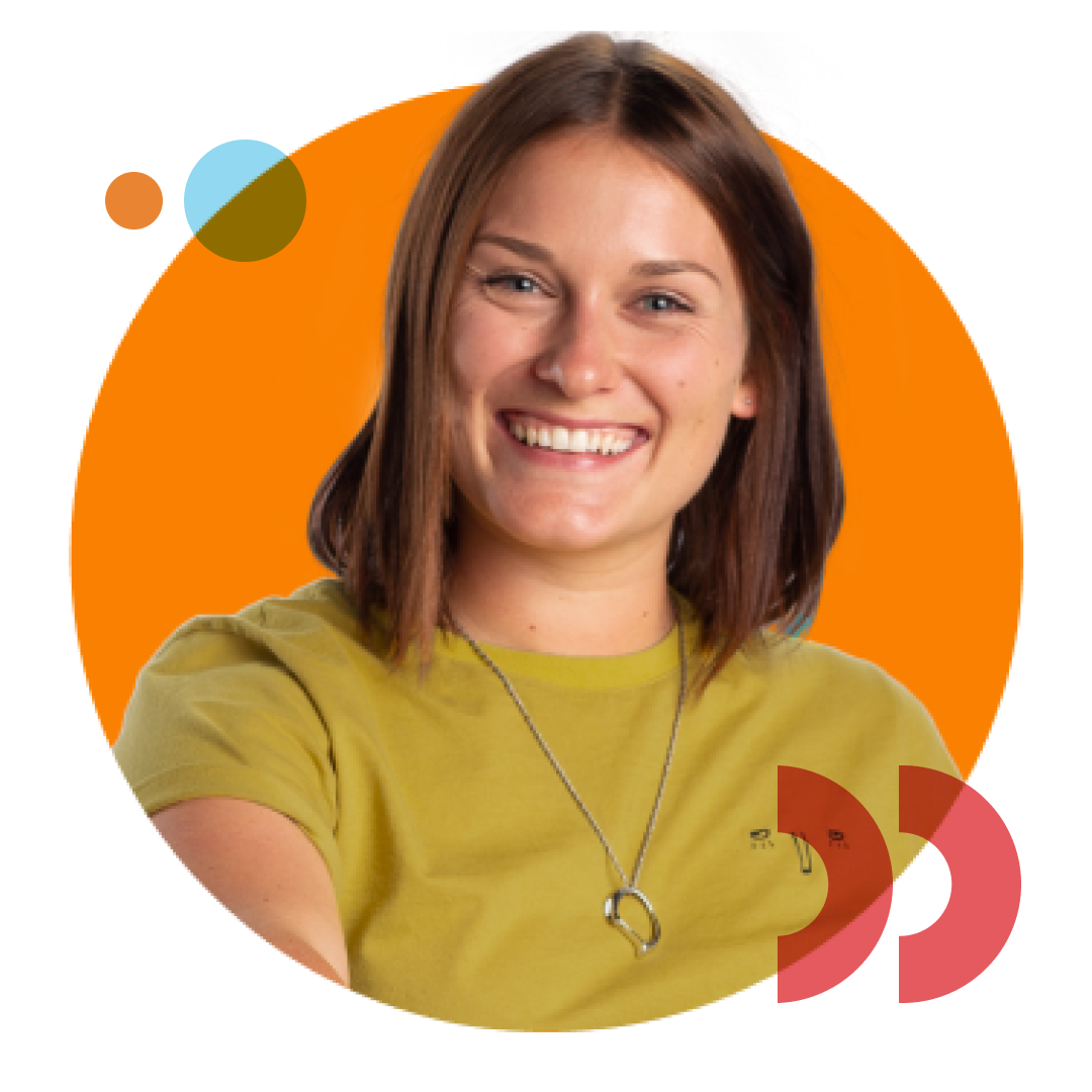 A widely smiling design grad