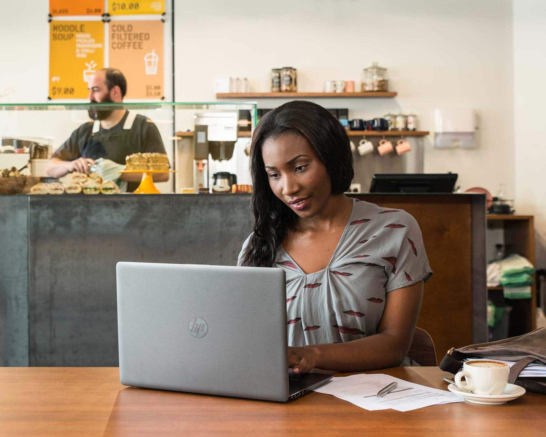 A restaurant owner uses accounting software on their laptop to run an efficient business.