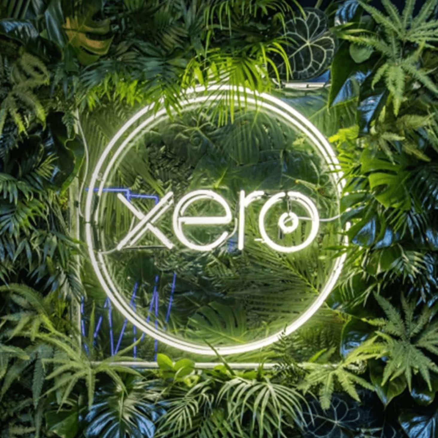 A Xero logo lights up against a backdrop of greenery in celebration of the many awards Xero has received in its regions.
