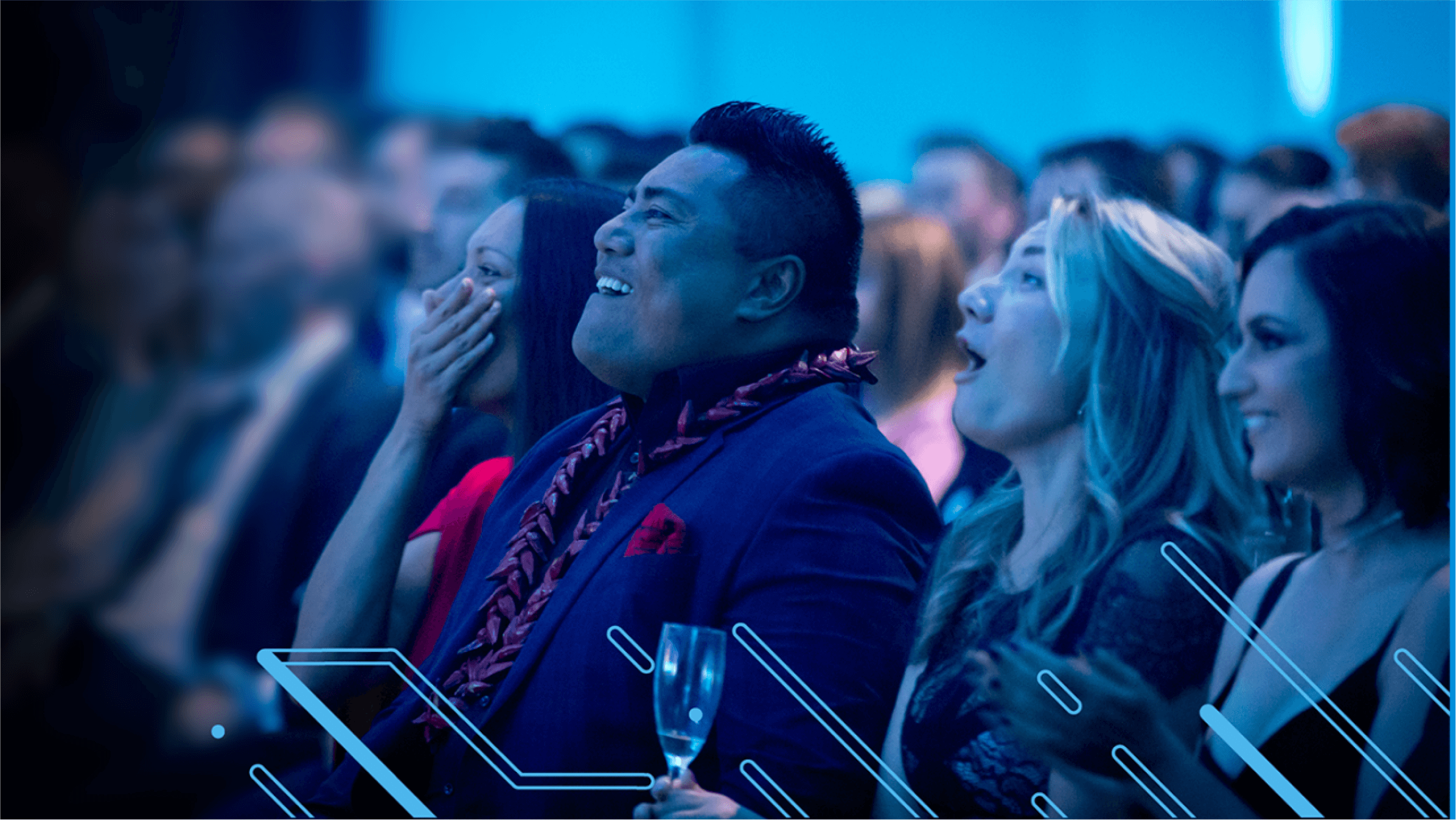 A seated row of accountants and bookkeepers at the NZ Xero Awards 2021 laugh at a joke made by the presenter.
