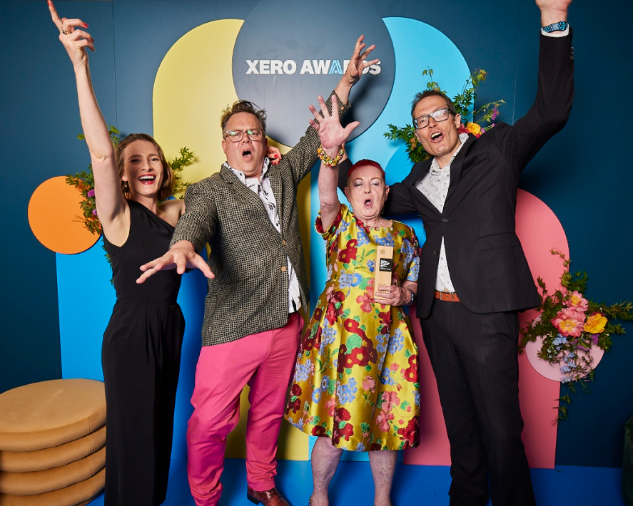 The Connected Accounting team raise their hands happily with their Medium Accounting Partner of the Year award