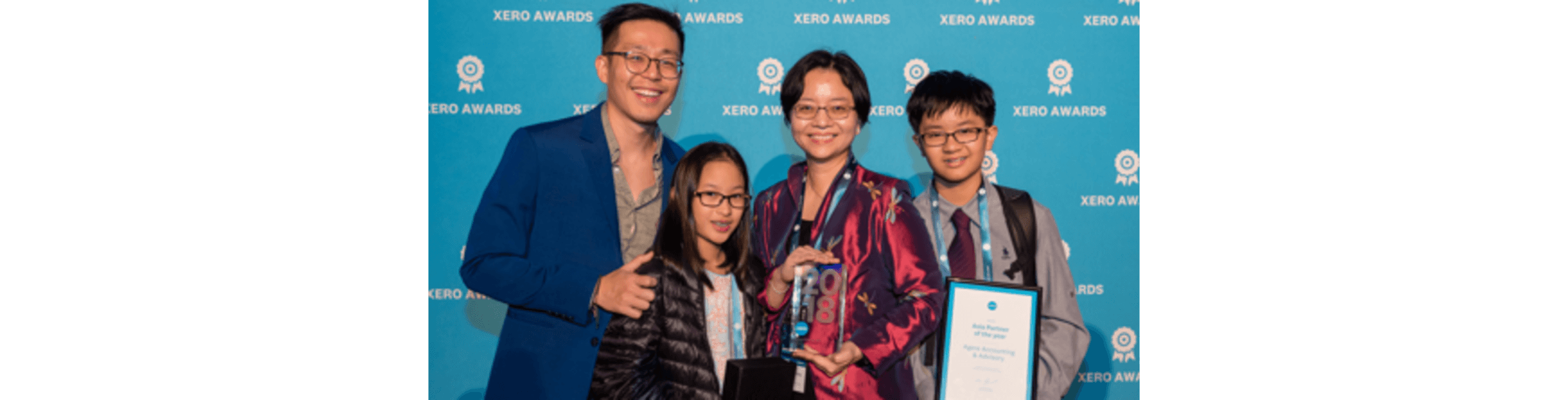 Agere founder Elaine Lim, second from right, and members of their family celebrate winning the Asia Partner of the Year award
