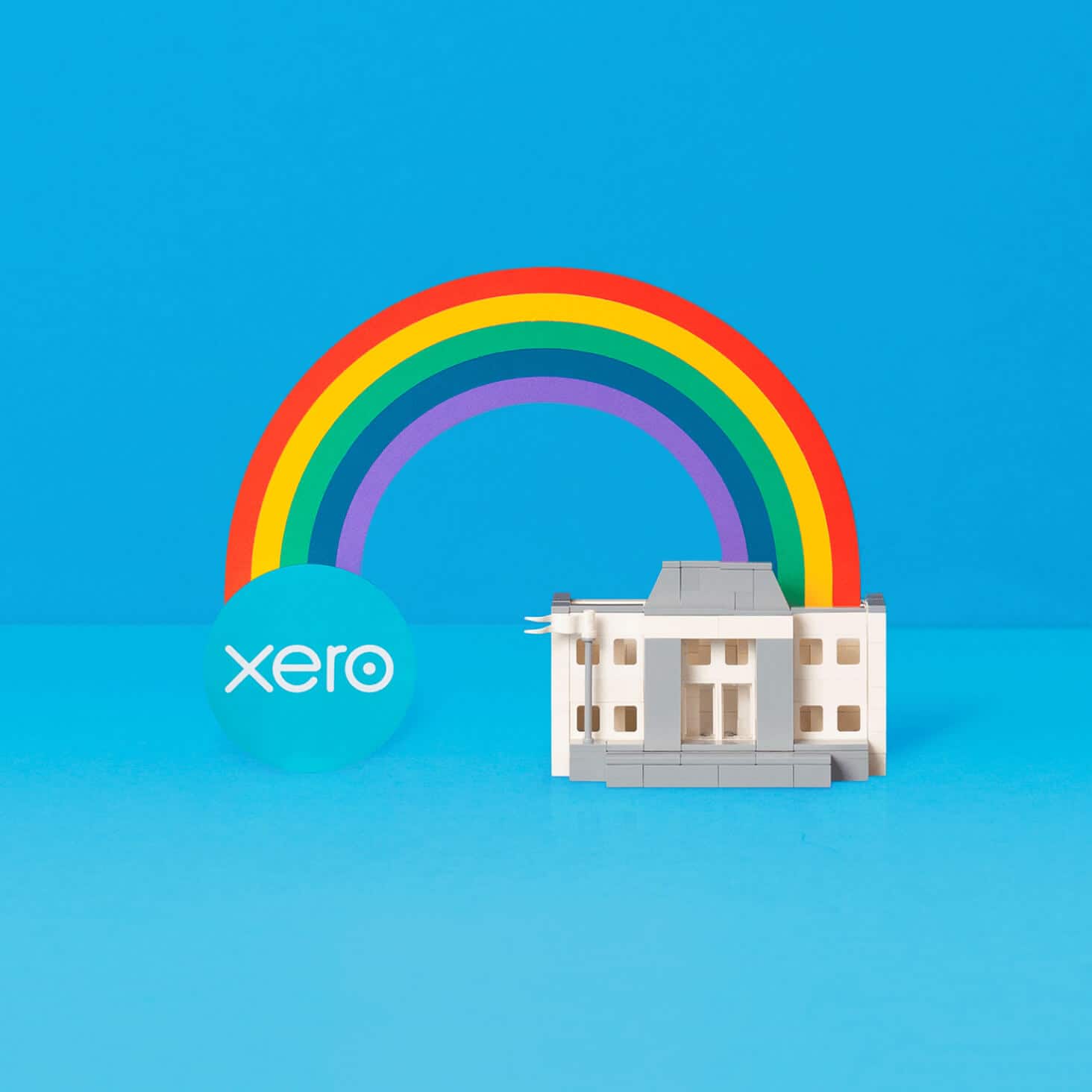 Xero logo connected to a bank by a rainbow 