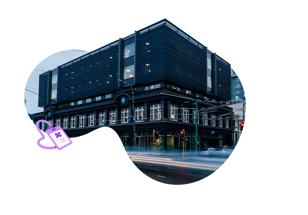 Three Xero employees with open laptops work together at a coffee table in a breakout area.