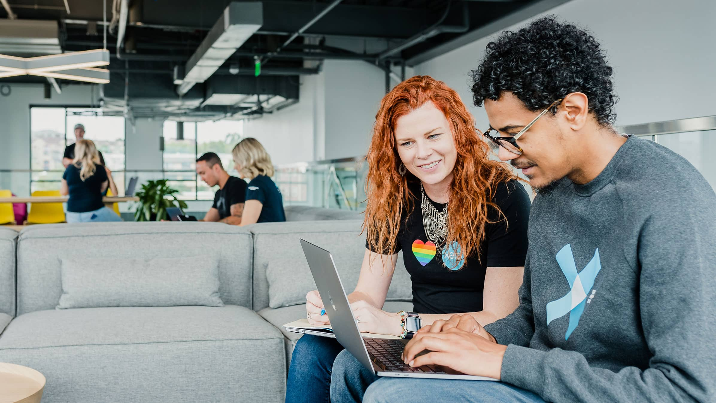 A Xero employee helps a new team member get up and running during their first day in the office.