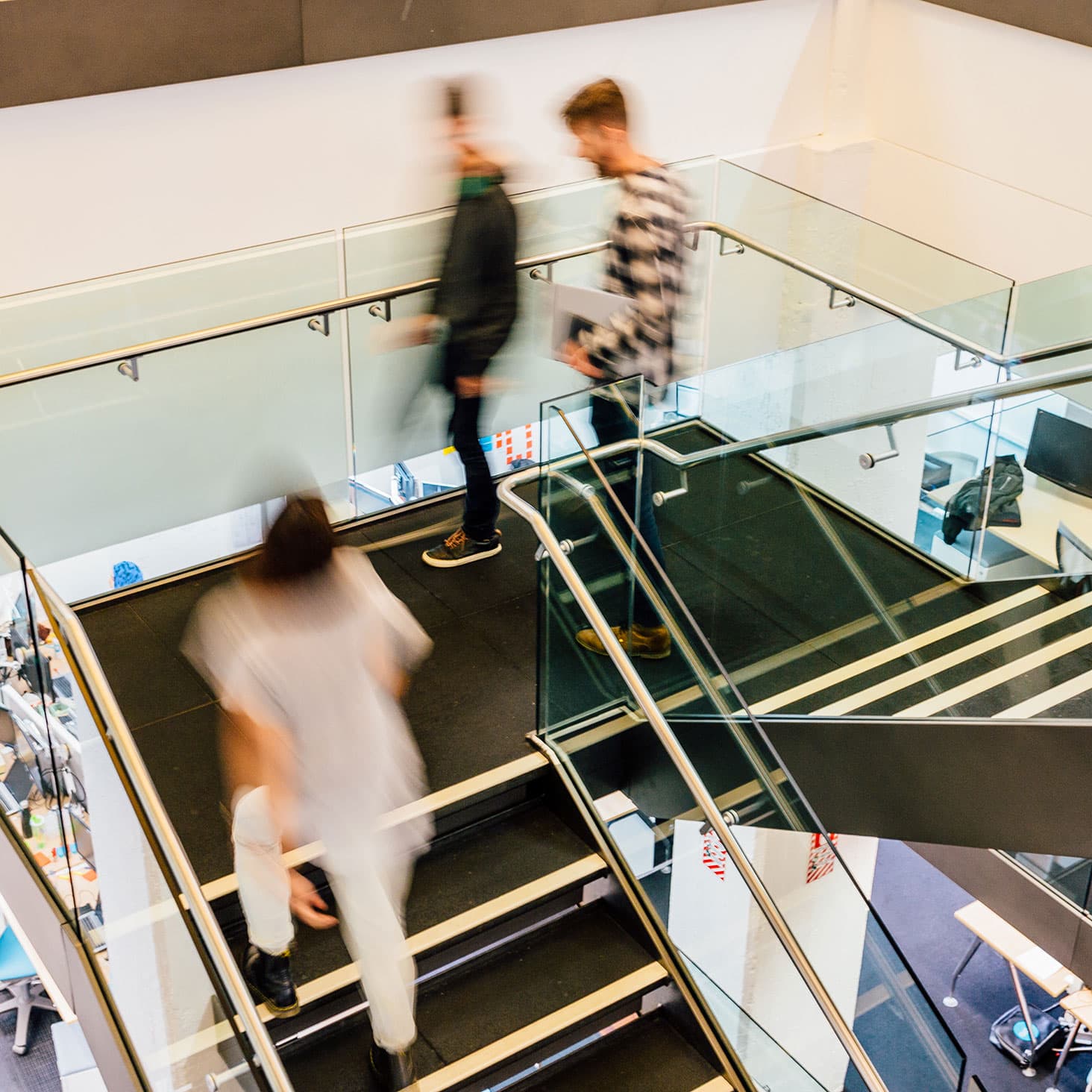 Office workers walking up a stairwell.