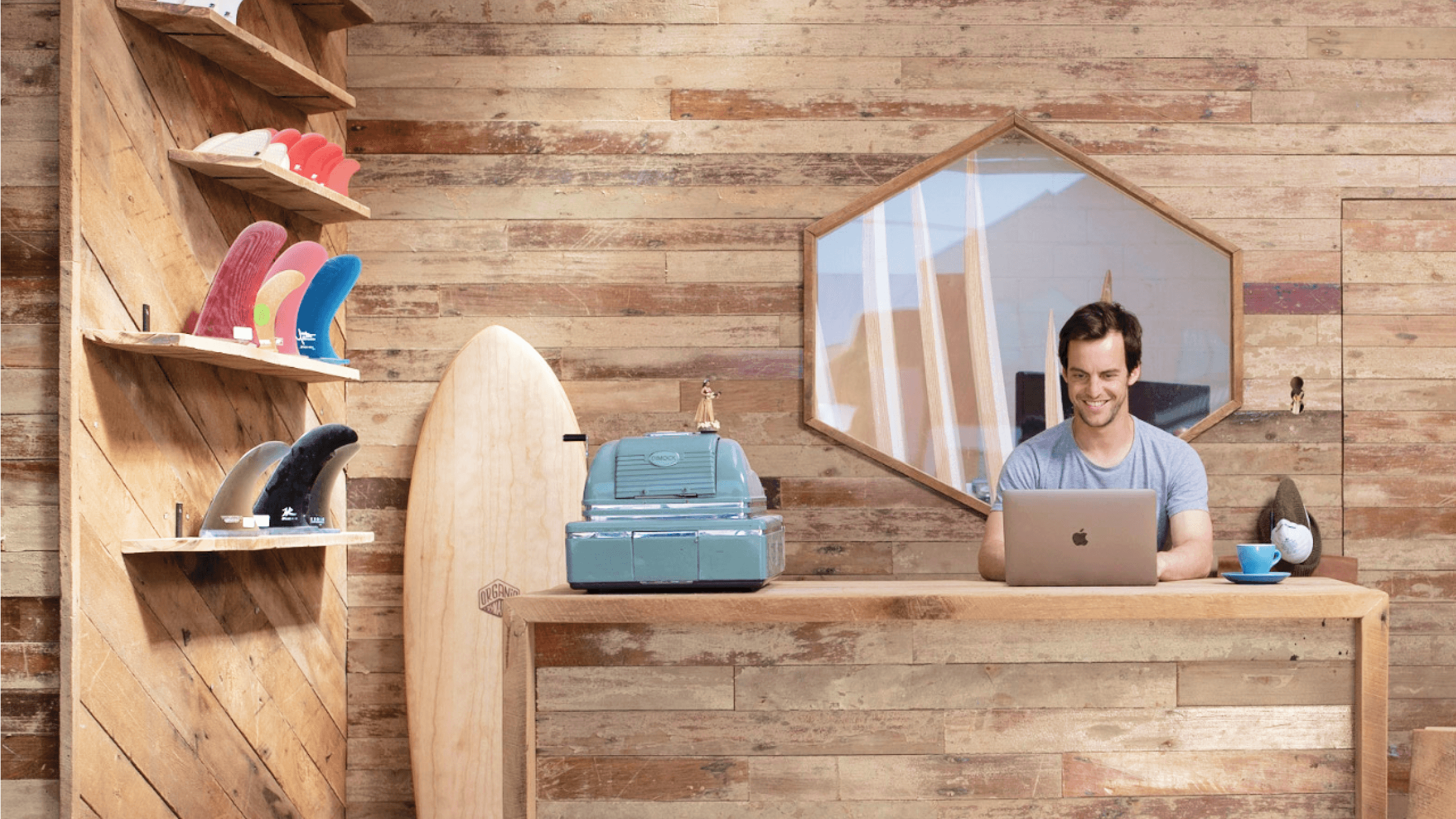 A surf shop owner reads about responsible data use for their business over a cup of coffee.