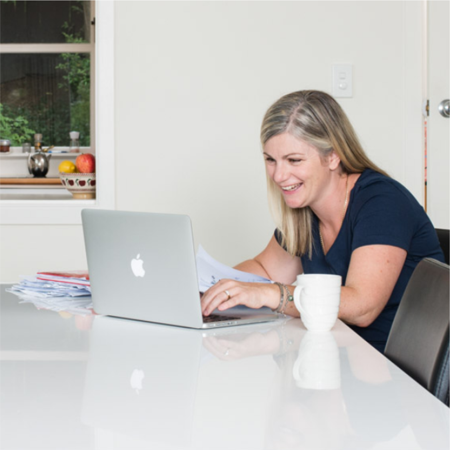 A woman using a laptop to look for accounting software that’s a good Sage alternative.