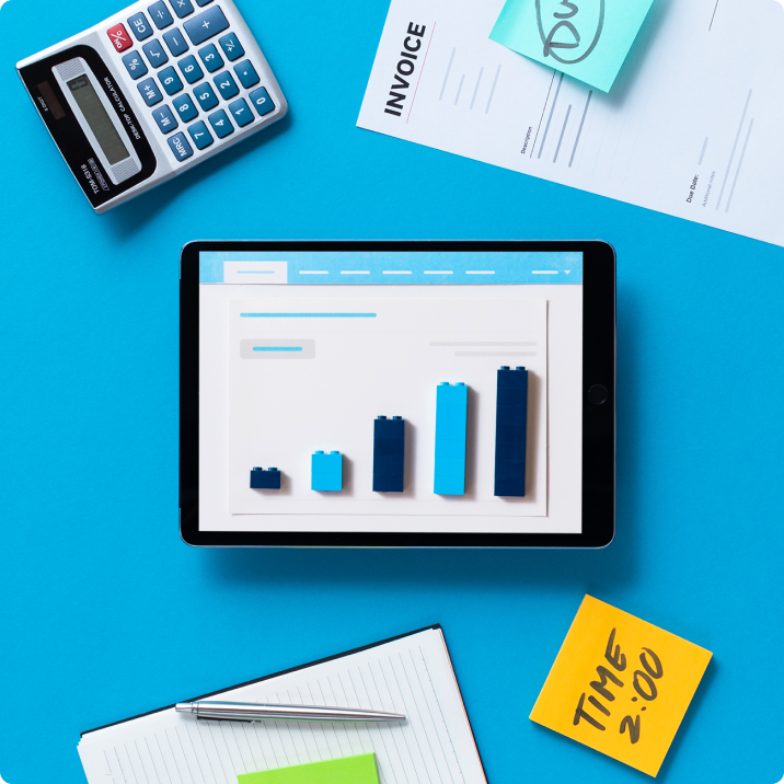 Illustration of Xero being used on an iPad, with a calculator, invoice, post-it notes, and notepad surrounding.