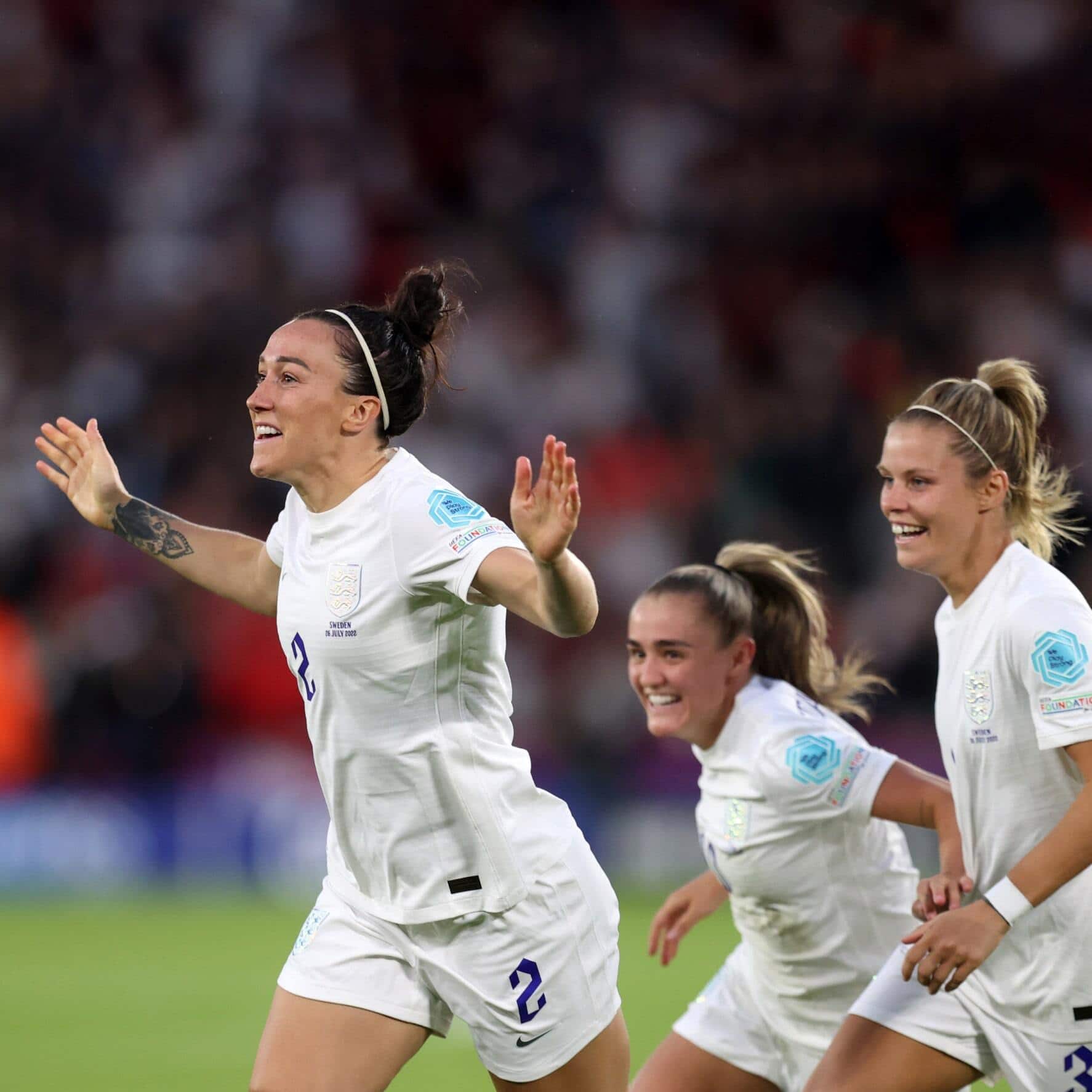 Lioness team members celebrate on the pitch