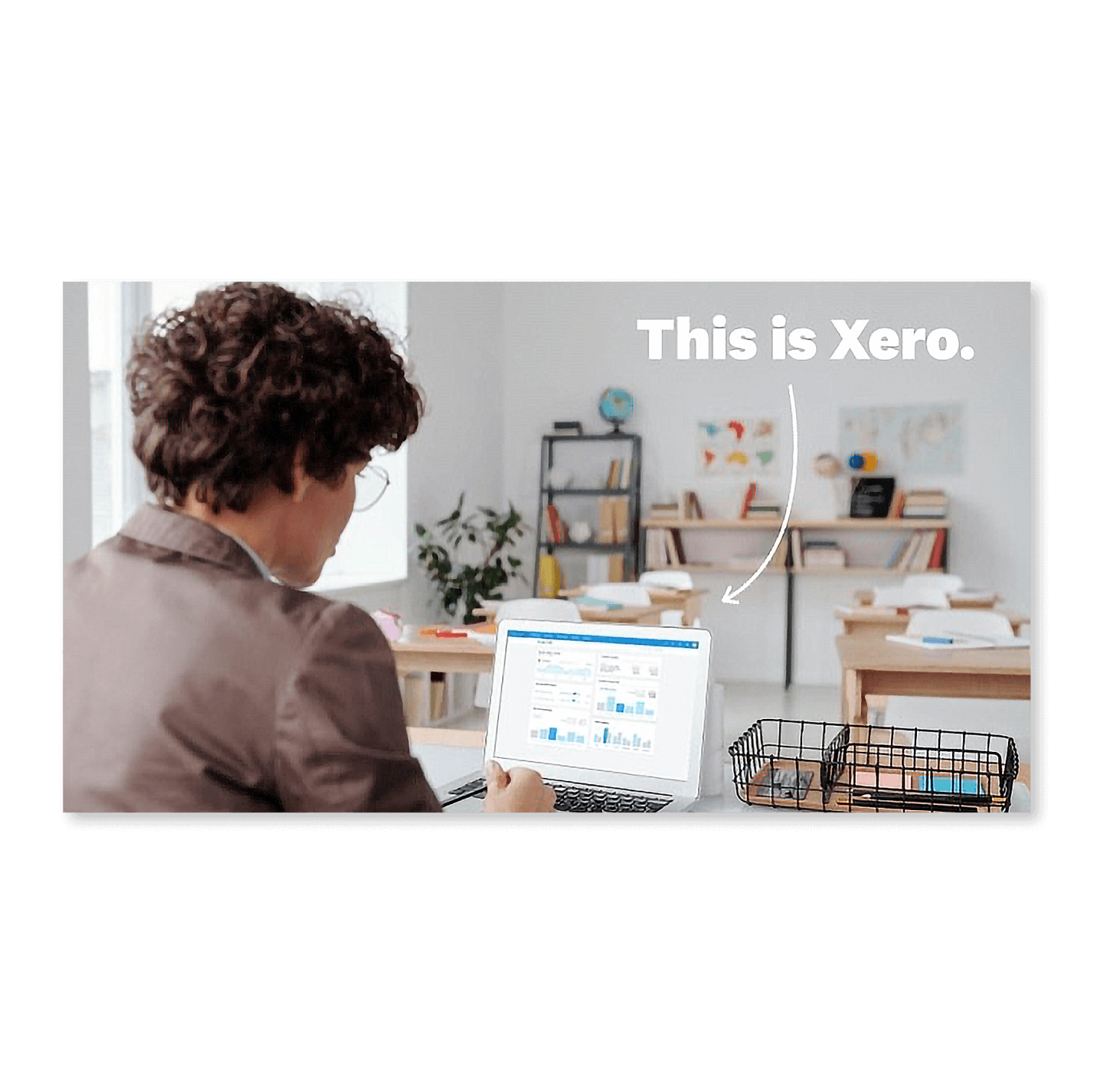 A small business owner sitting in their office, working with Xero on their notebook computer.