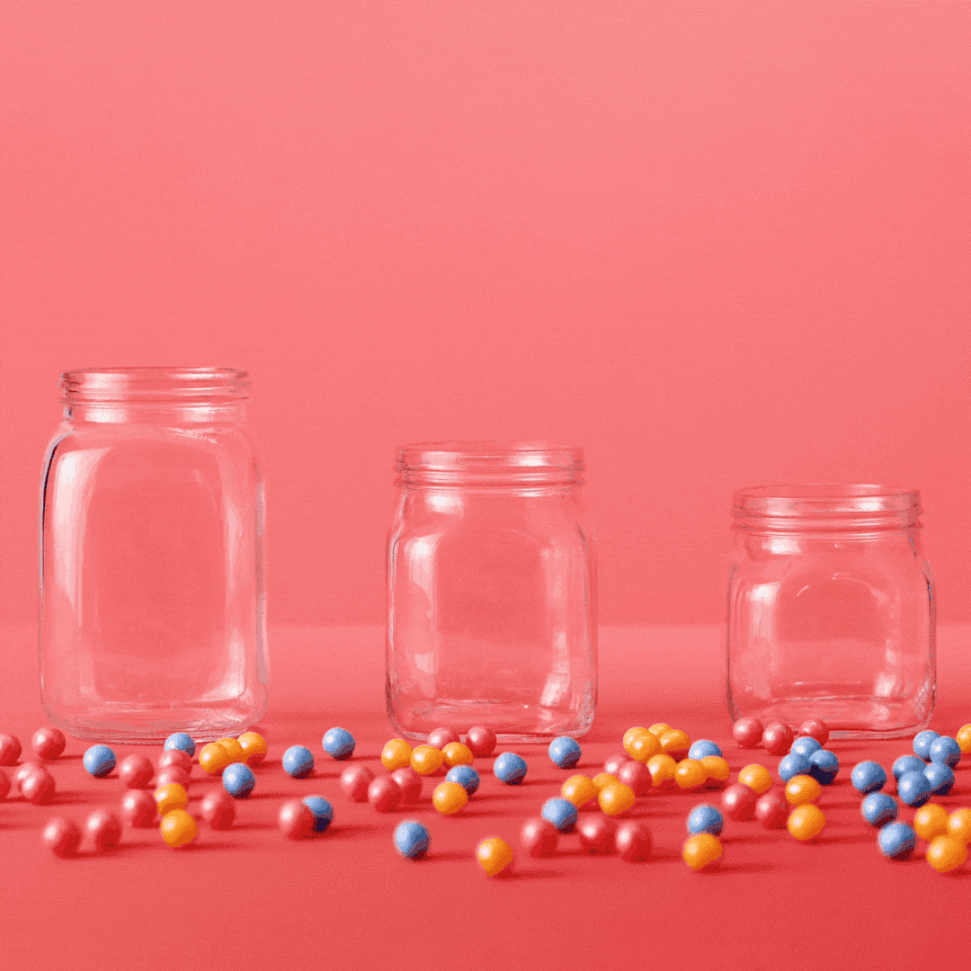 Gum balls being placed in jars by respective colors.