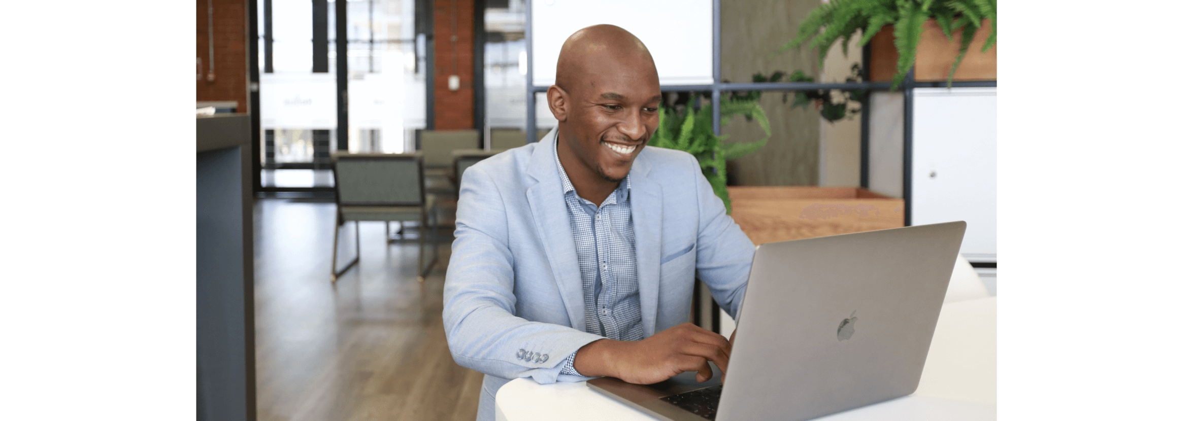 A business owner works on their laptop in a co-working space.