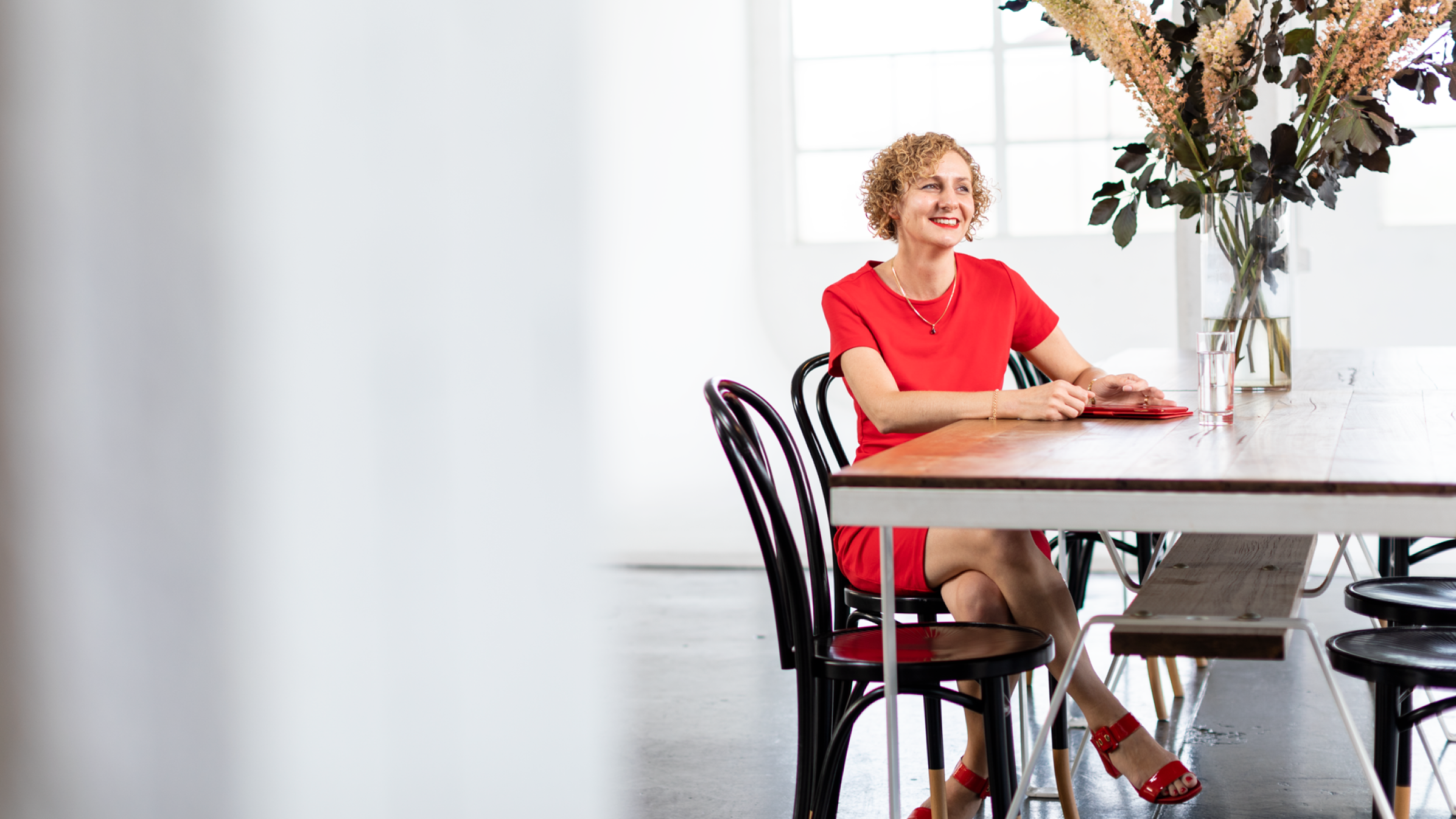 An accountant sits at a table, smiling, after signing up to the Xero partner program.