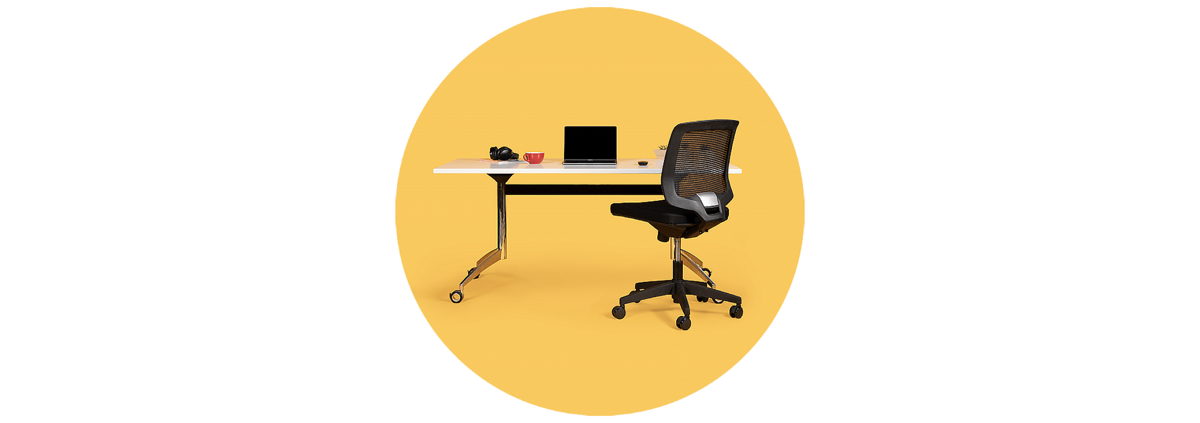 A sit-stand desk and ergonomic chair used as a permanently allocated workstation in the Rewired space.