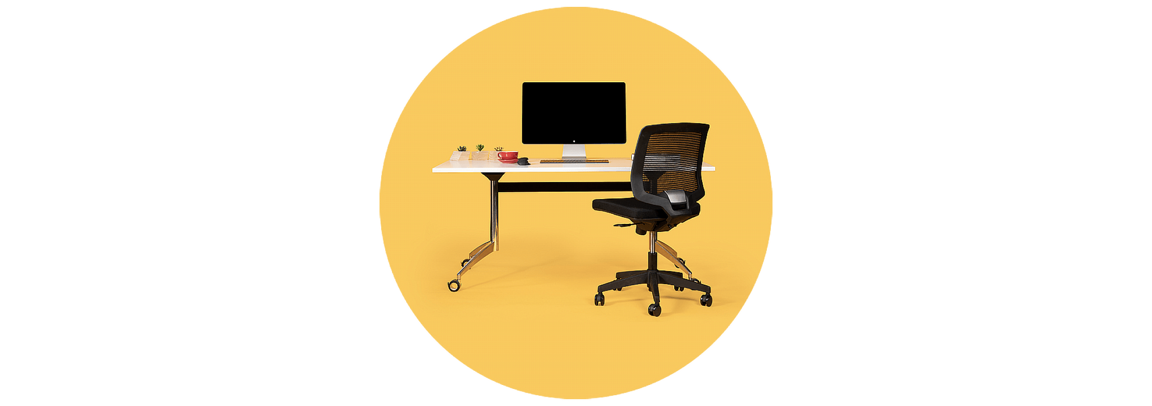 A sit-stand desk and ergonomic chair used as a hot desk in the Rewired space.