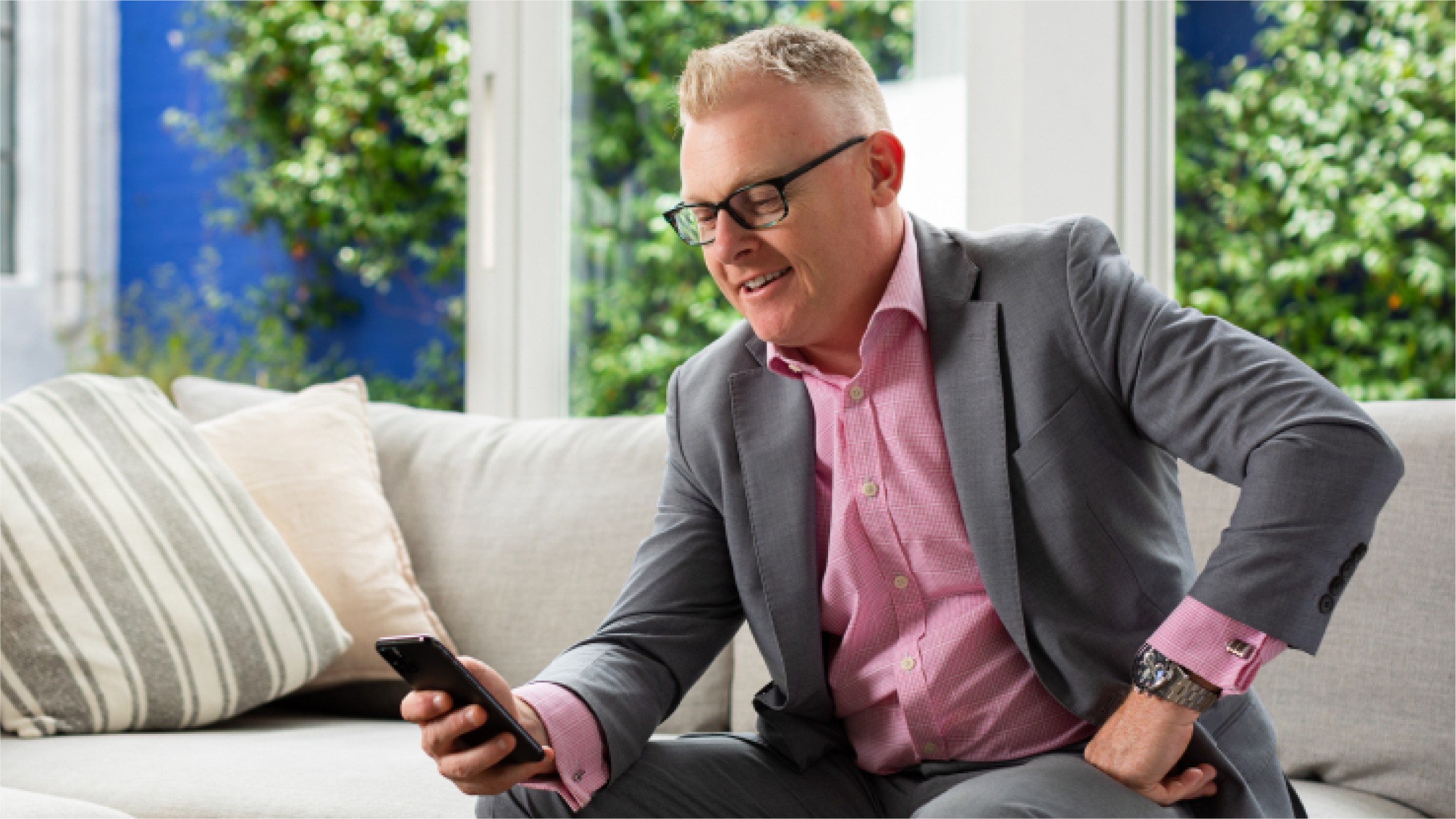 An accountant checks the accounts of a self-employed client on the Smarter plan on their phone. 