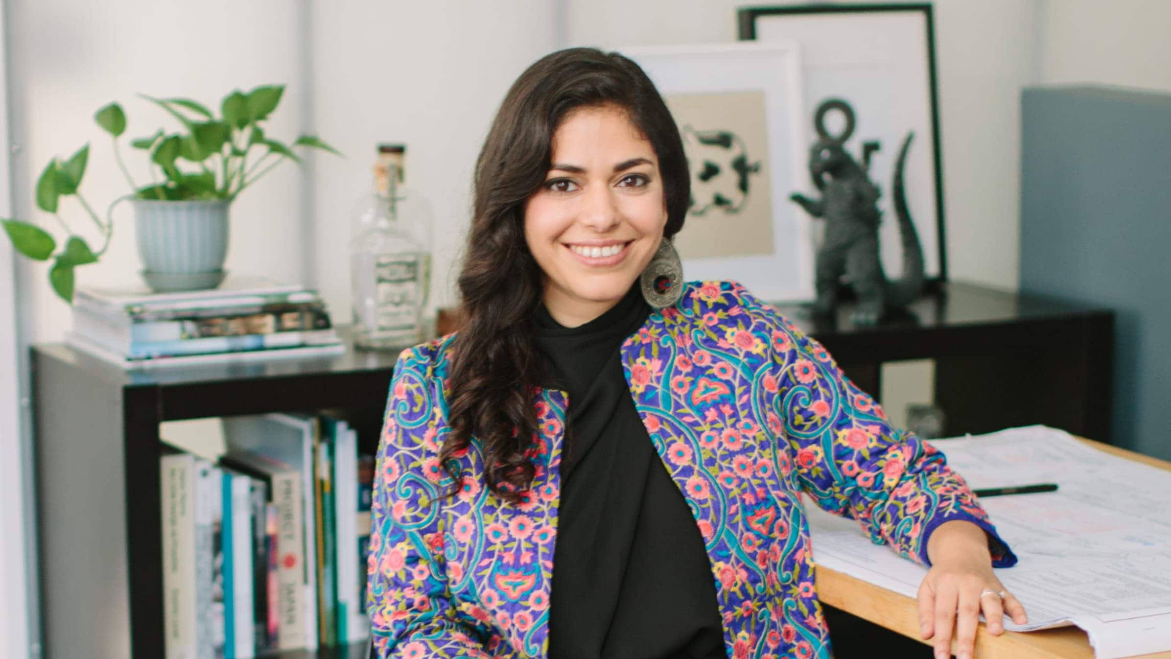 Nastaran Mousavi, co-owner of Studio BANAA, sitting in her studio smiling at the camera