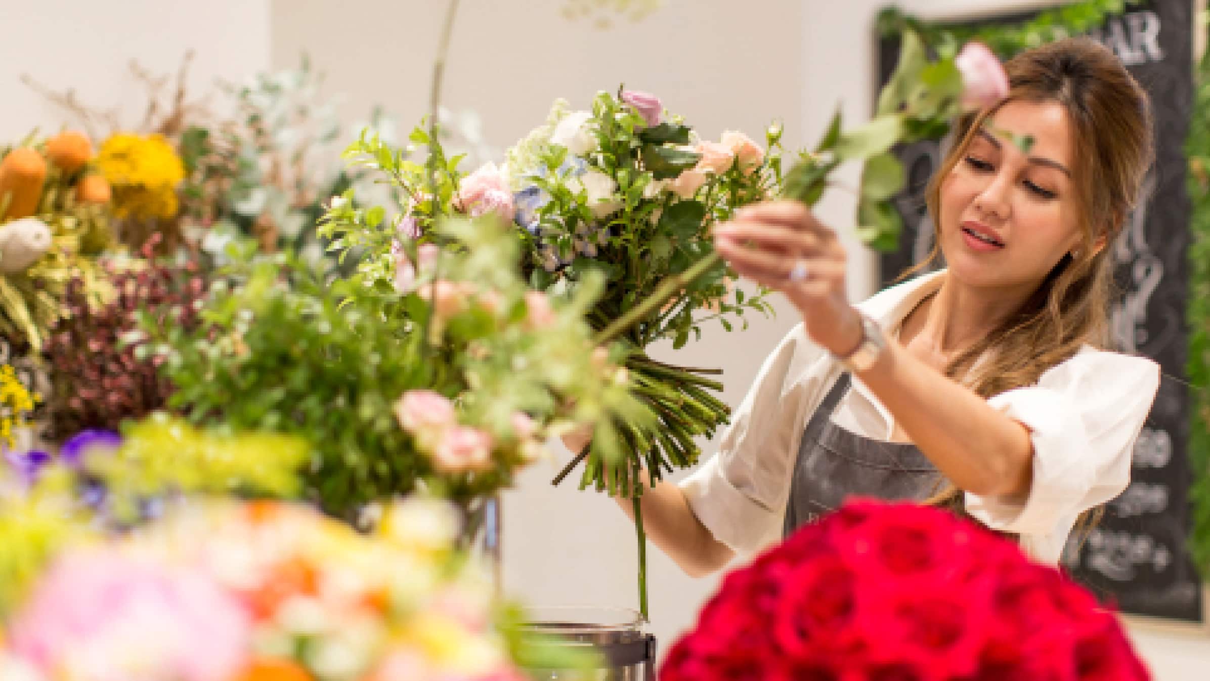 Lelian Chew, founder of The Florist Atelier, arranging flowers in her store.