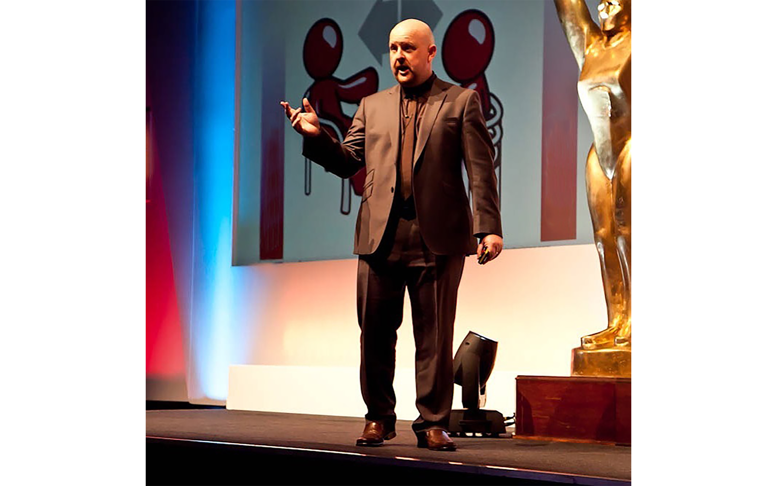 Sean McPheat of MTD Training delivering a speech on stage