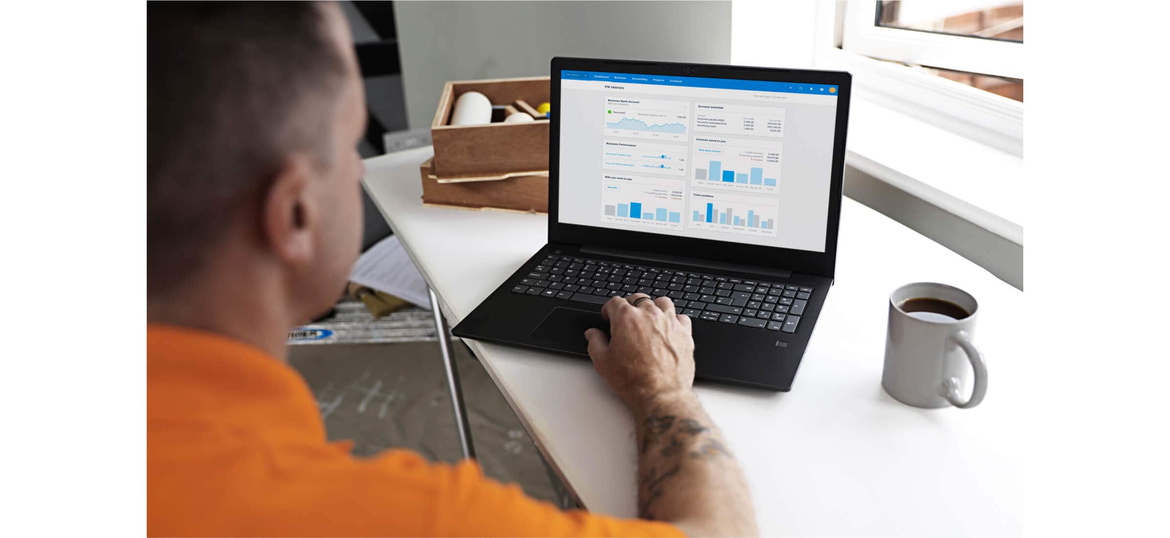 Paul Walden doing accounts on Xero on a notebook computer.