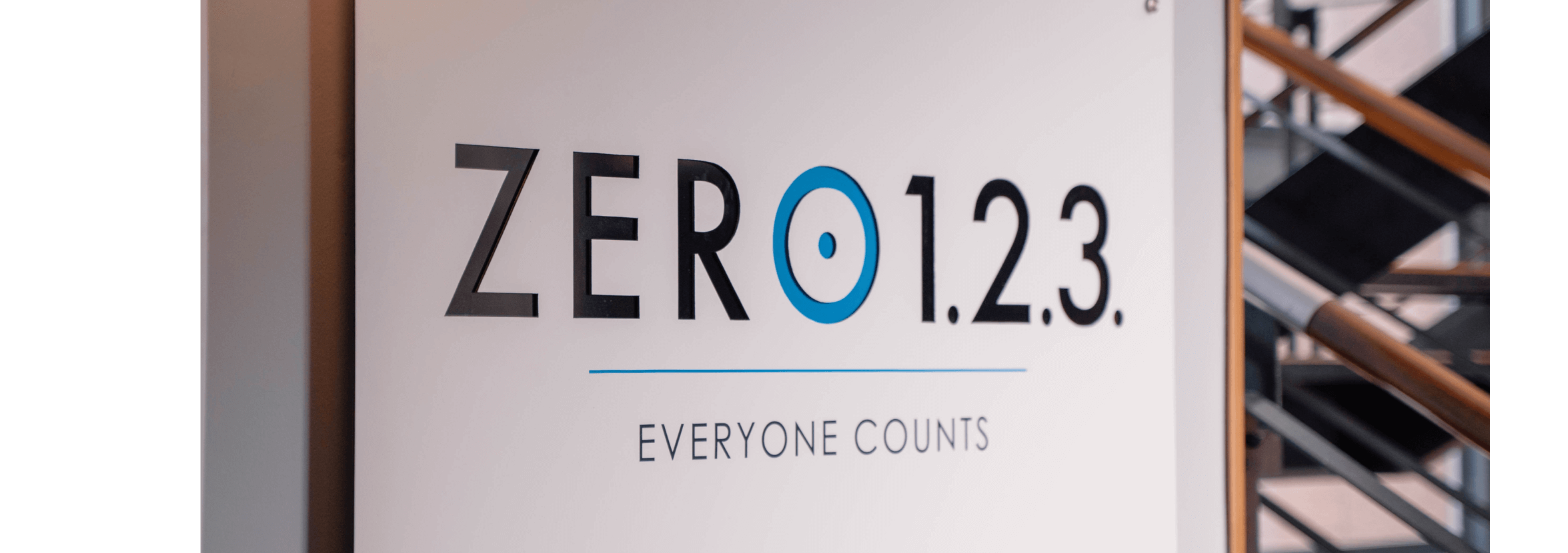 A sign with the words ‘Zero 1.2.3. Everyone counts’ on it.