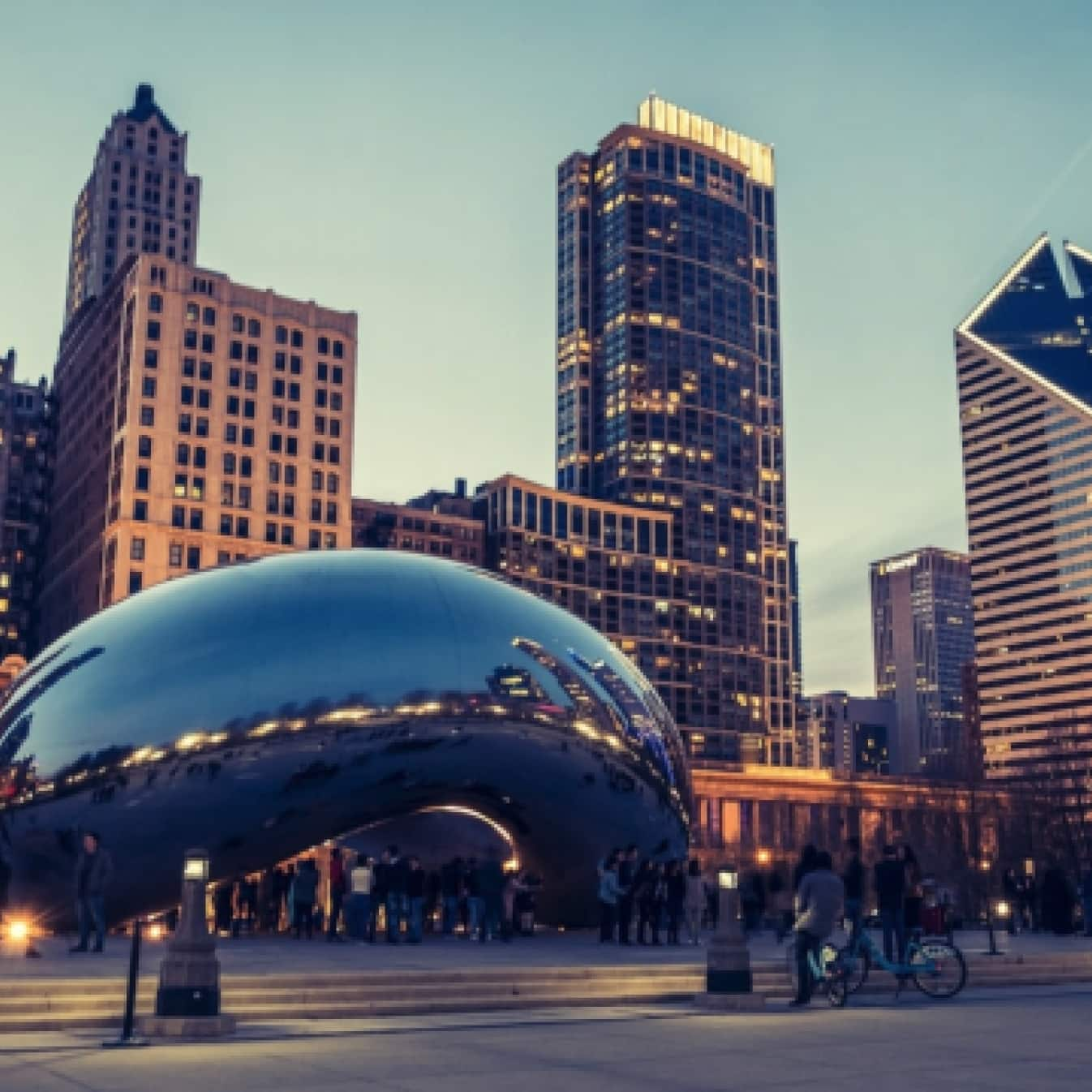 The Cloud Gate sculpture and city buildings in downtown Chicago.