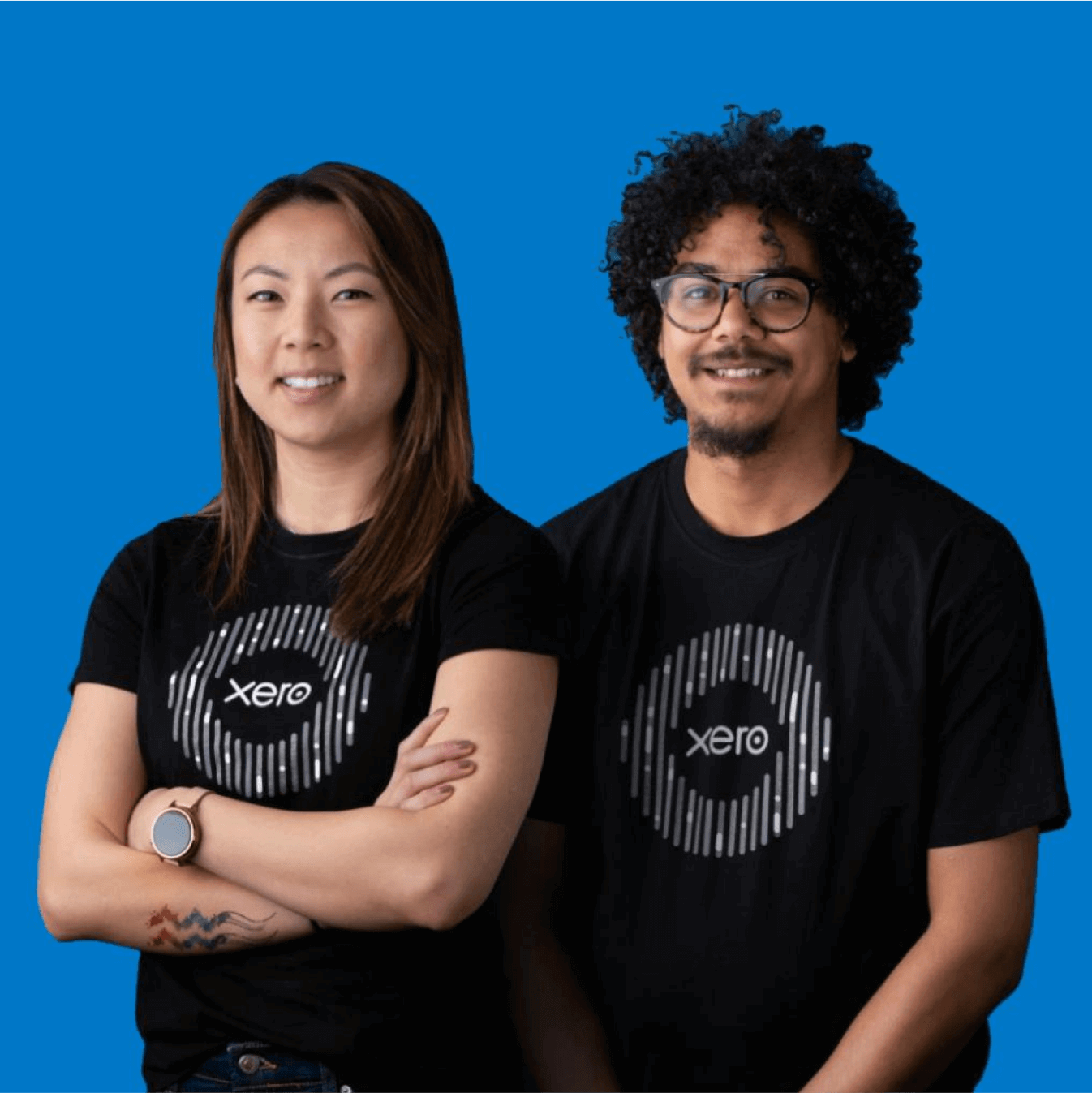 Two smiling Xero employees wearing black Xero tee-shirts.