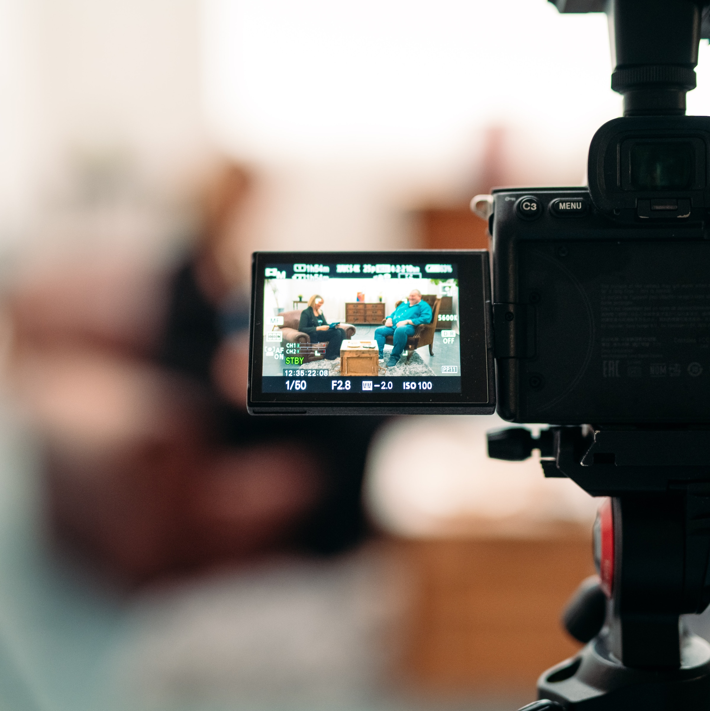 A camera on a stand filming an interview.