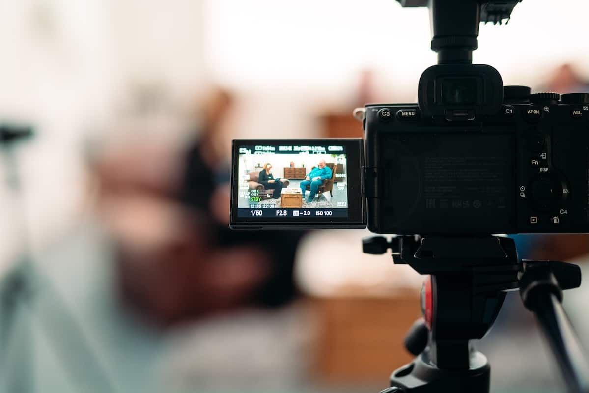 A camera on a stand filming an interview.