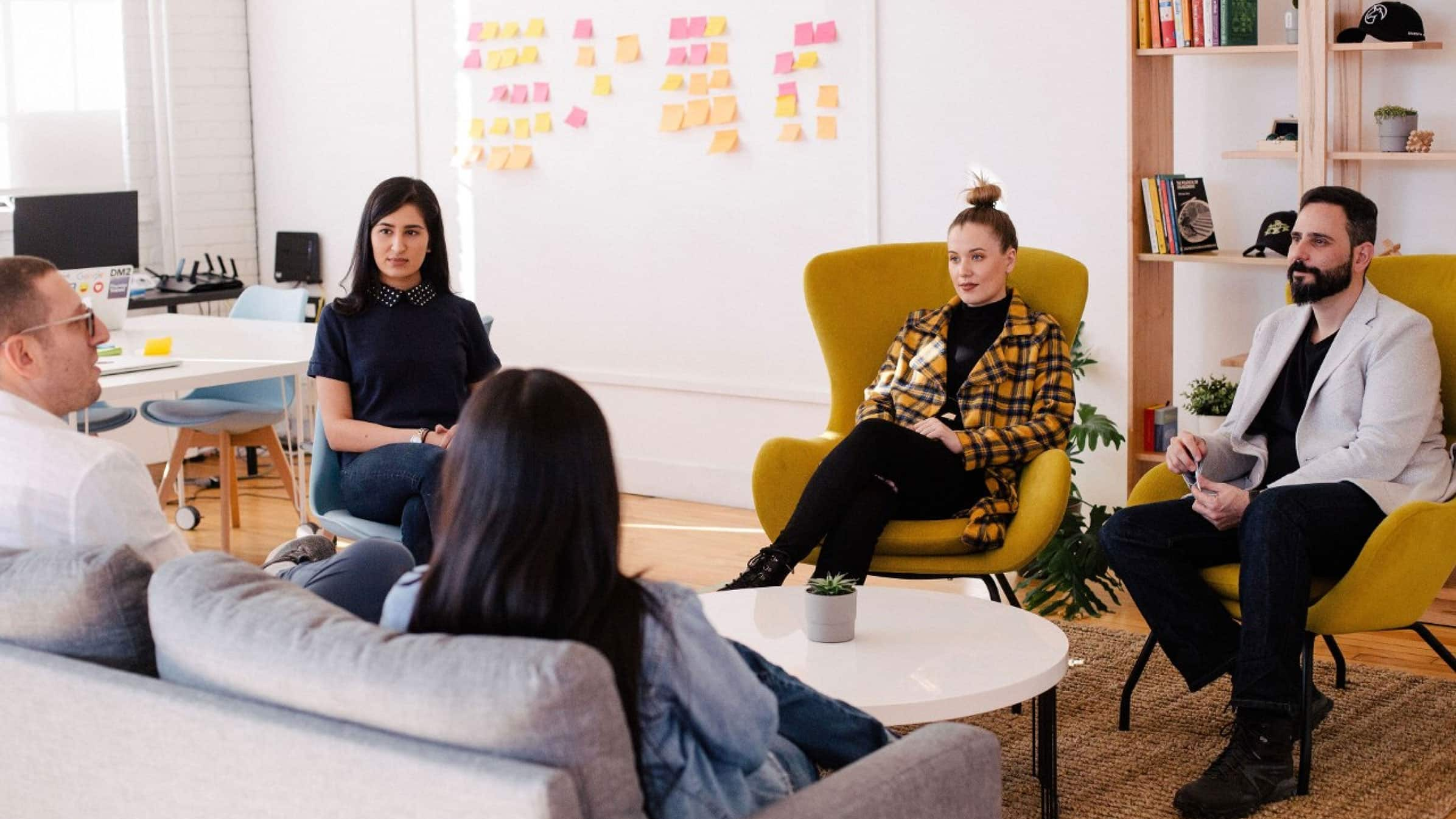 embers of a product team gather around a table for their weekly catch-up. 