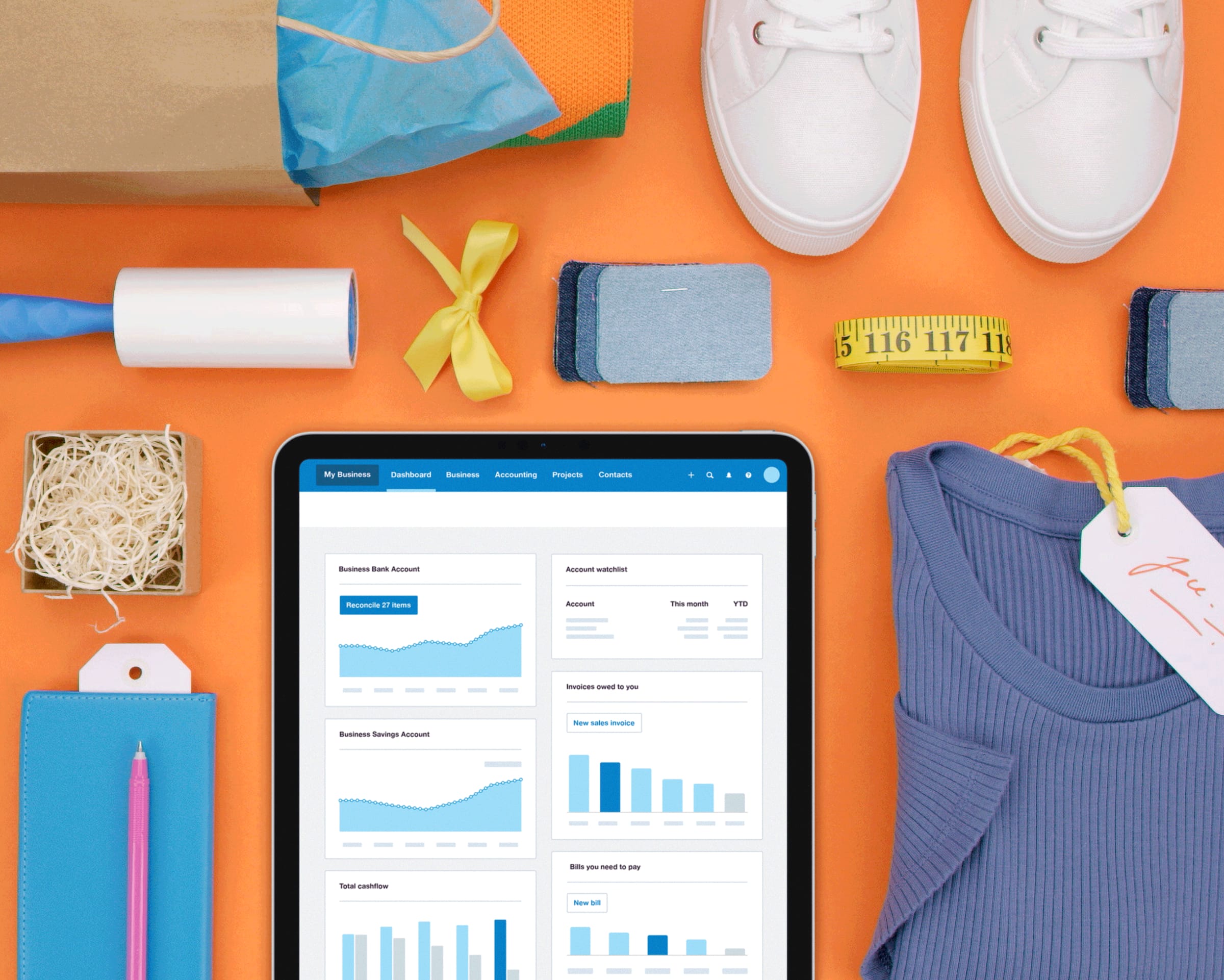 The Xero dashboard open on an iPad, surrounded by a shopping bag, and a range of new purchases.