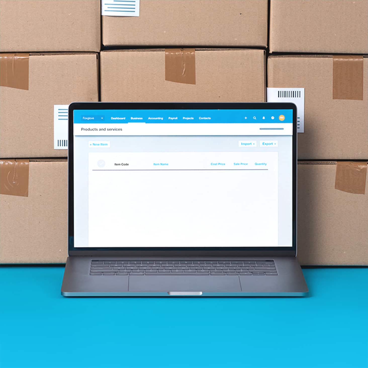 Unopened boxes containing new stock are stacked near a laptop that displays items in inventory management software.